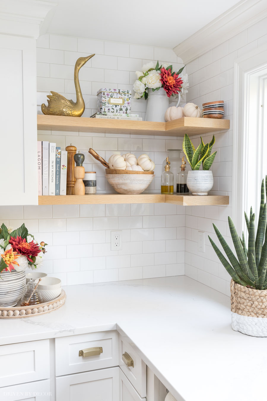 Open corner shelving in a kitchen is the perfect place to add a few fall touches with baby boo pumpkins!