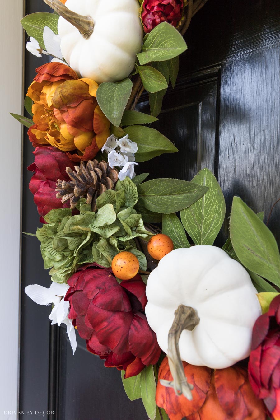 This fall wreath is a stunner! Filled with faux pumpkins, pinecones, and dark peonies!