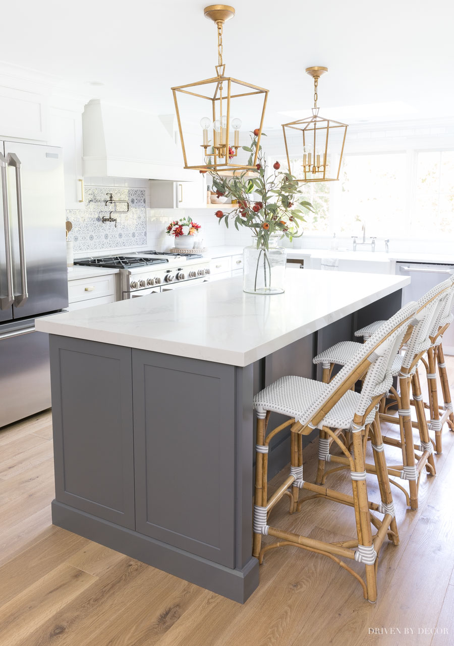 SUCH helpful tips about hanging lights over a kitchen island including how many to use, how far apart, and more!