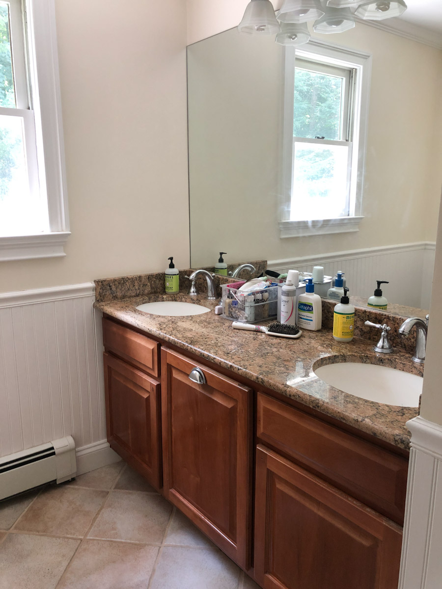 white bathroom cabinets with dark countertops