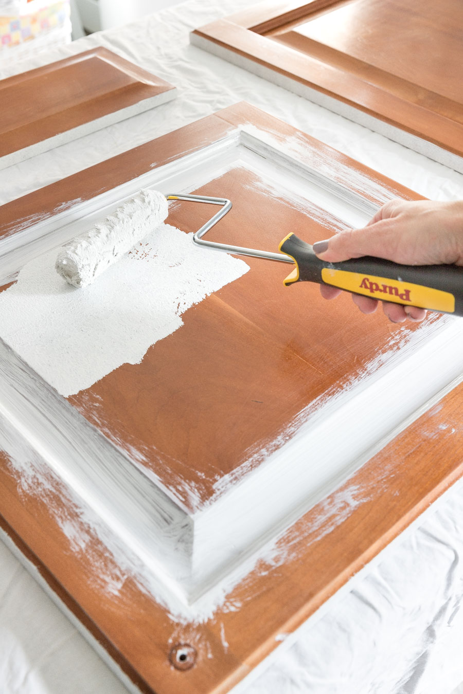 Rollering on the primer is the next step in painting your bathroom vanity