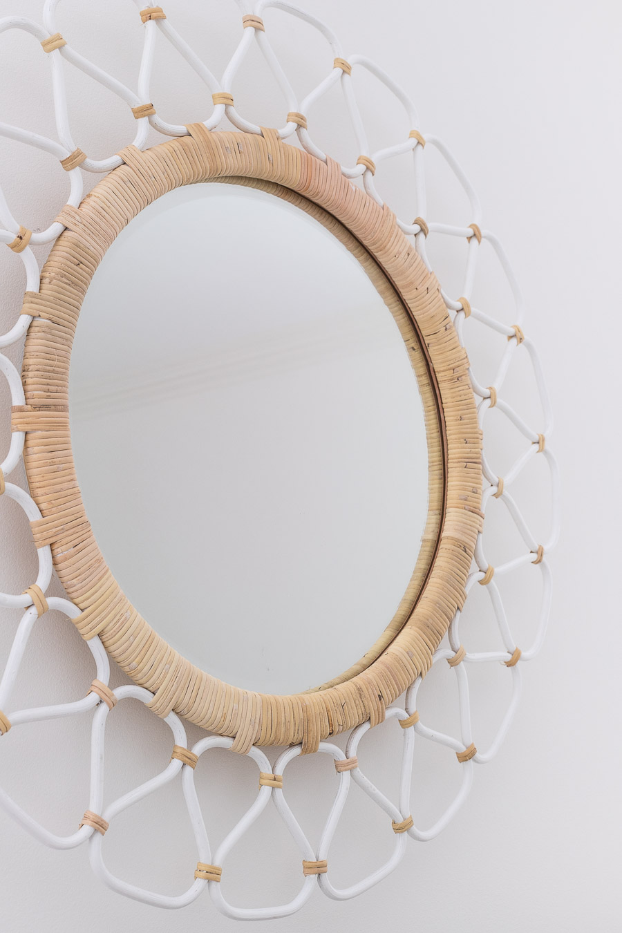 This rattan mirror looks so good above her bed! Love the colors and texture!