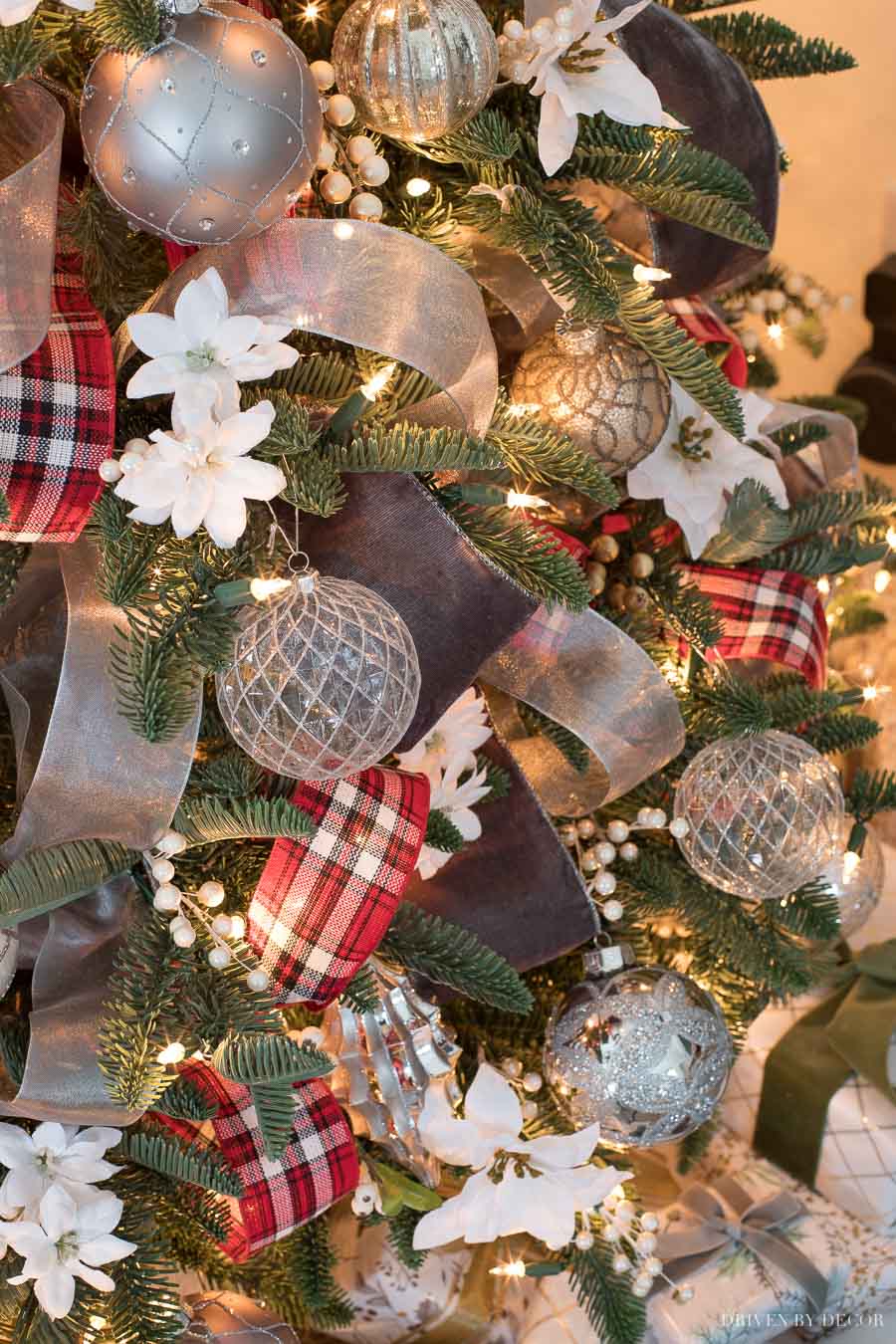 A mix of wide gray velvet, red plaid, and sheer silver ribbon on our Christmas tree!