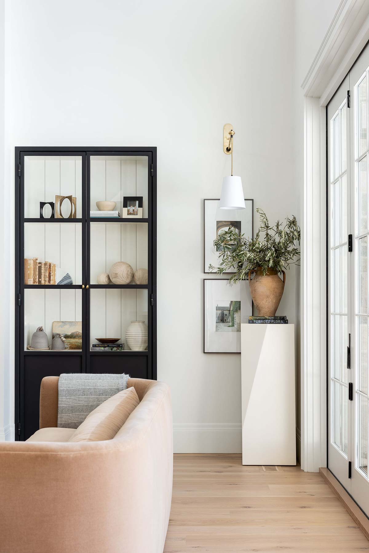 Potted plant on pedestal in living room corner