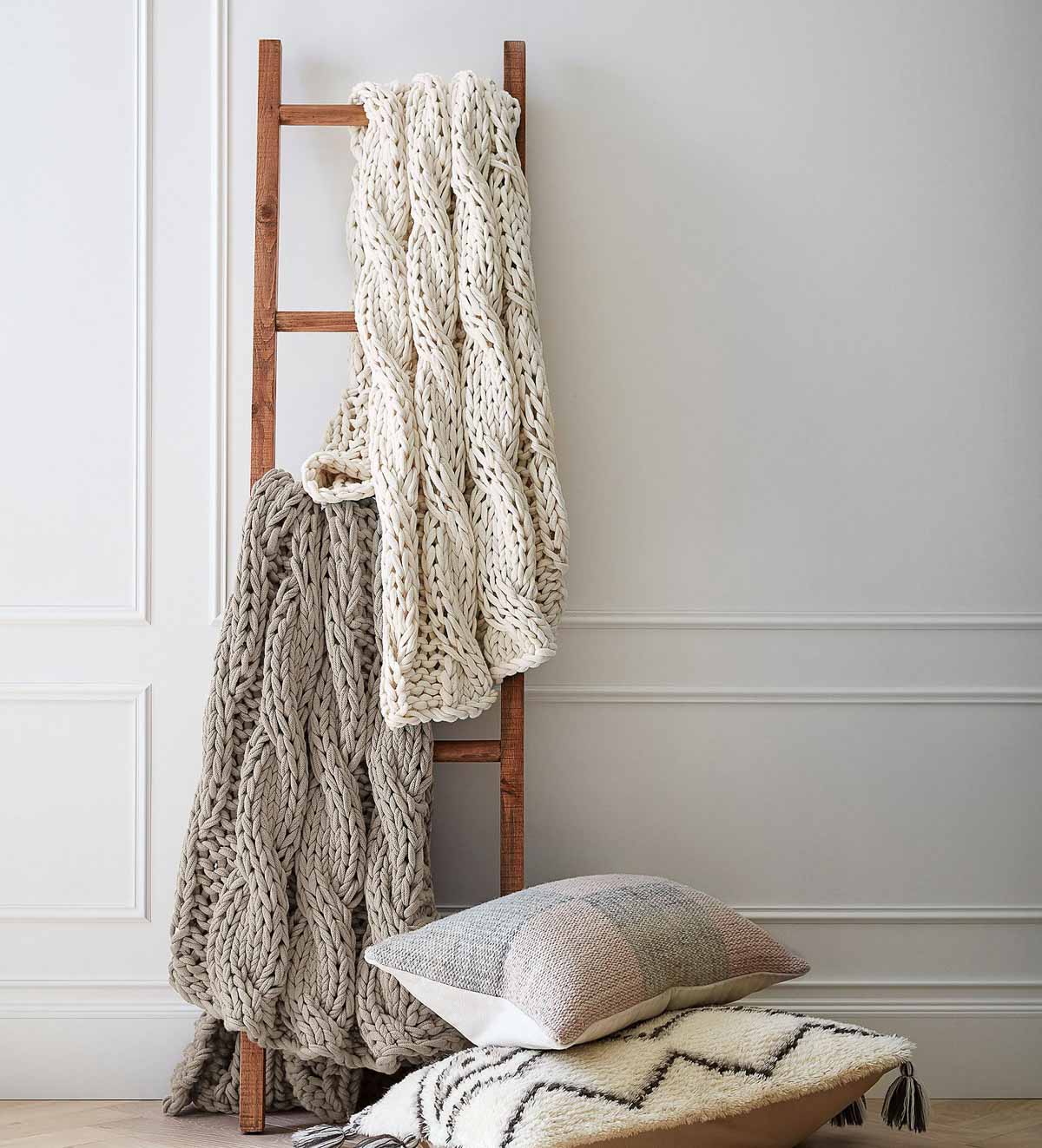 Rustic reclaimed ladder with blankets on rungs