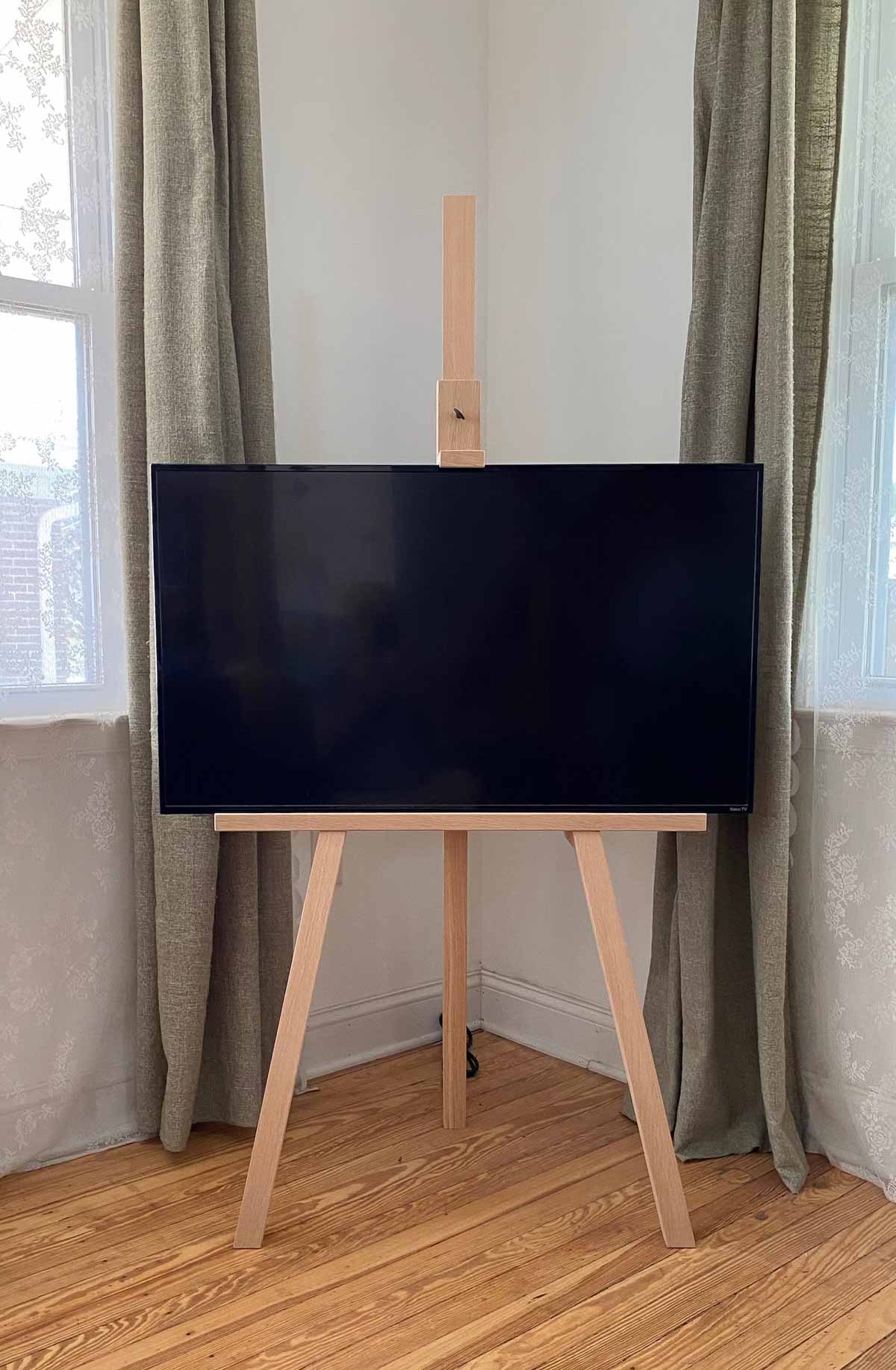 Wood TV easel in living room corner