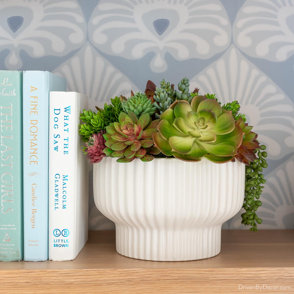 Faux succulents in a bowl on wood shelf - favorite Amazon home decor