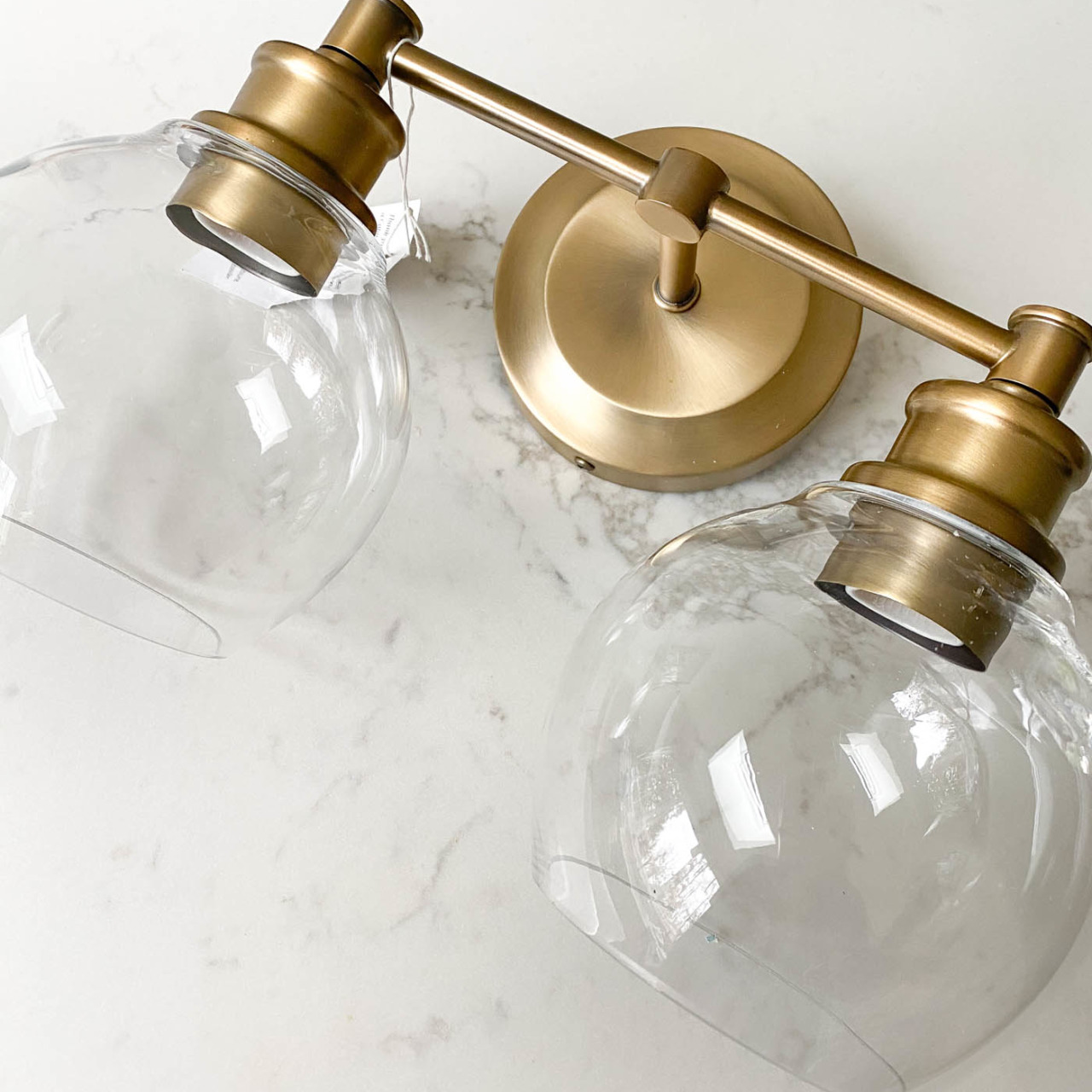 Love these two-light brass globe lights for over a bathroom vanity mirror!