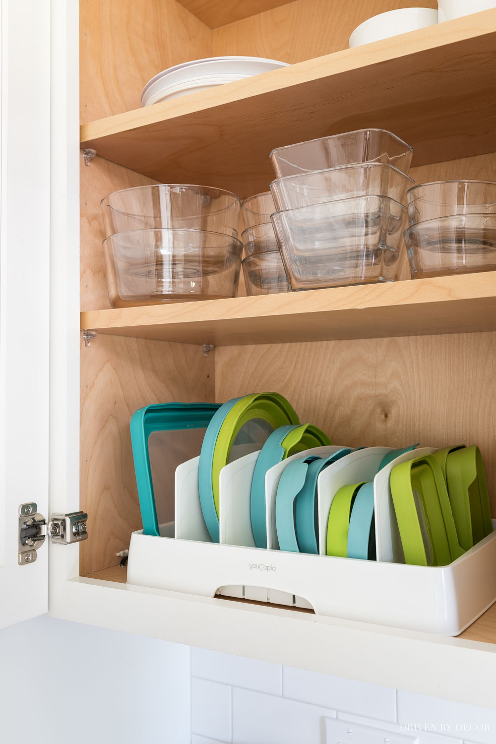 This lid organizer helps organize your kitchen (especially your food storage containers!) on a budget!