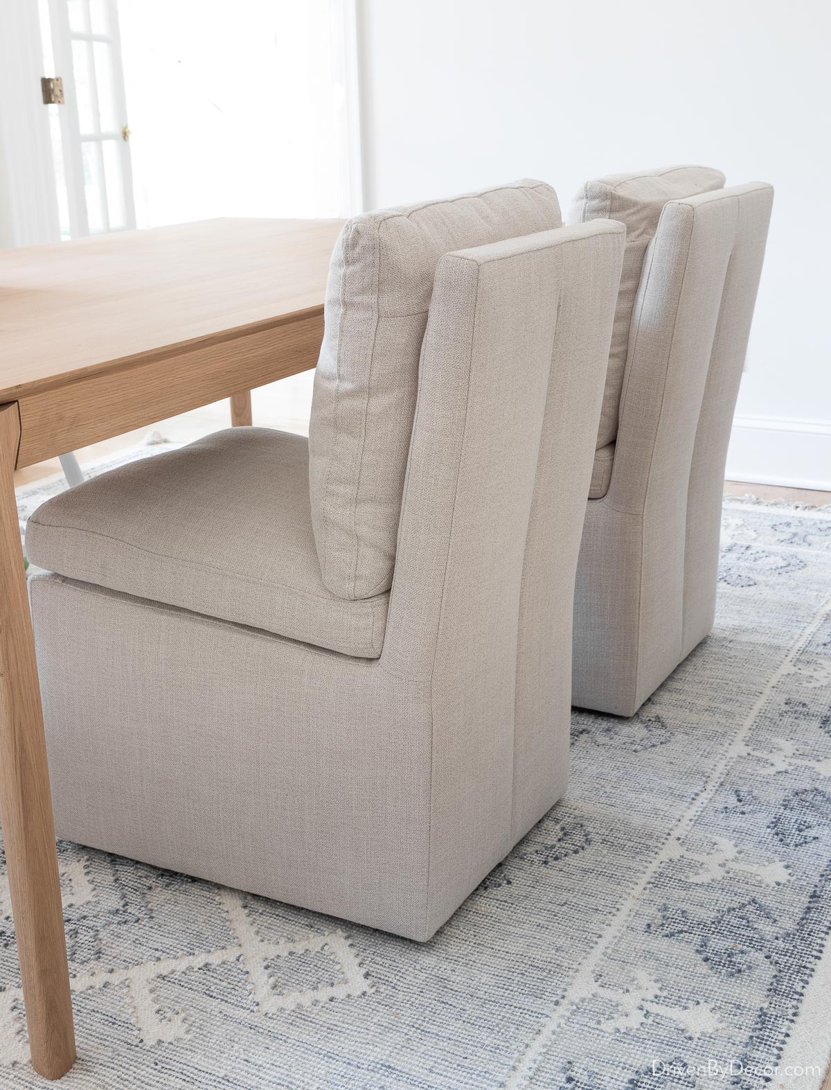 Upholstered dining chairs with detailing on the back
