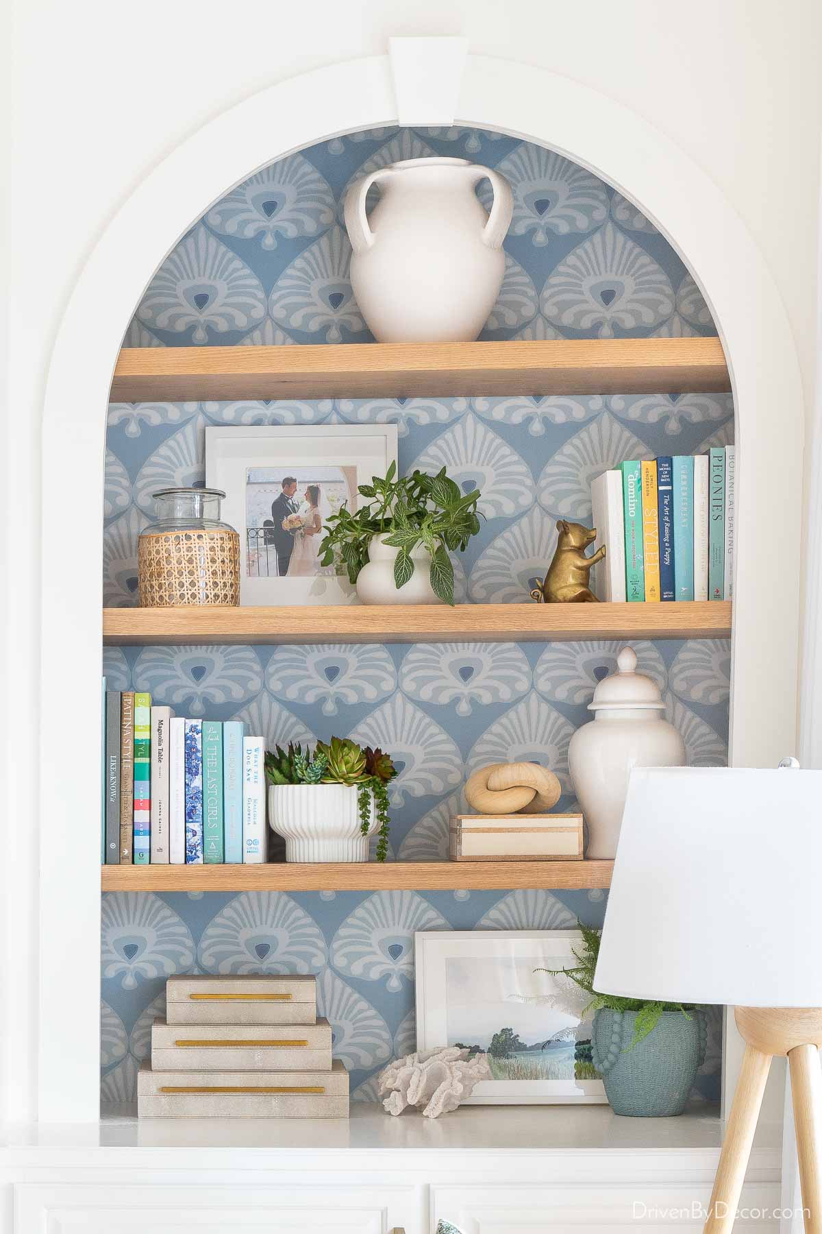 Blue patterned wallpaper on the back of a bookcase