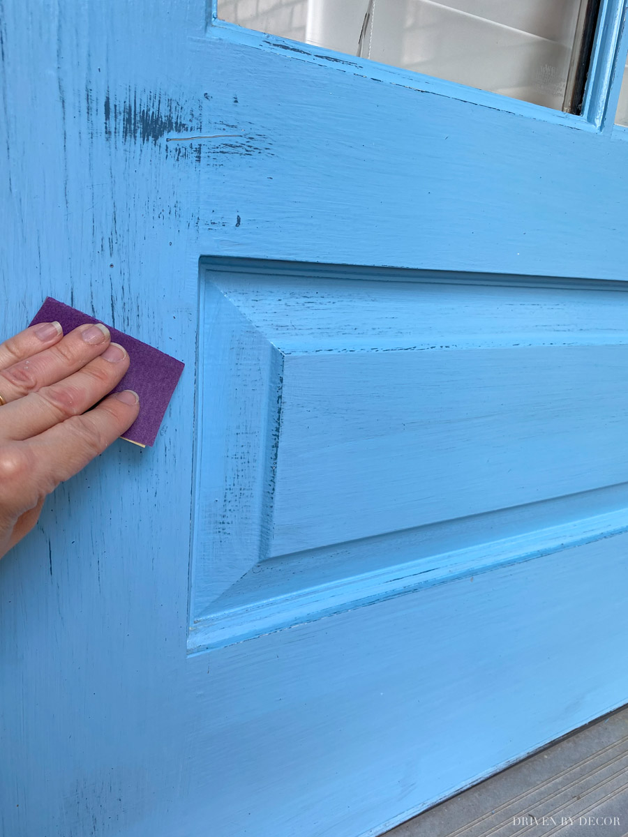 Prep your front door for paint by lightly sanding it