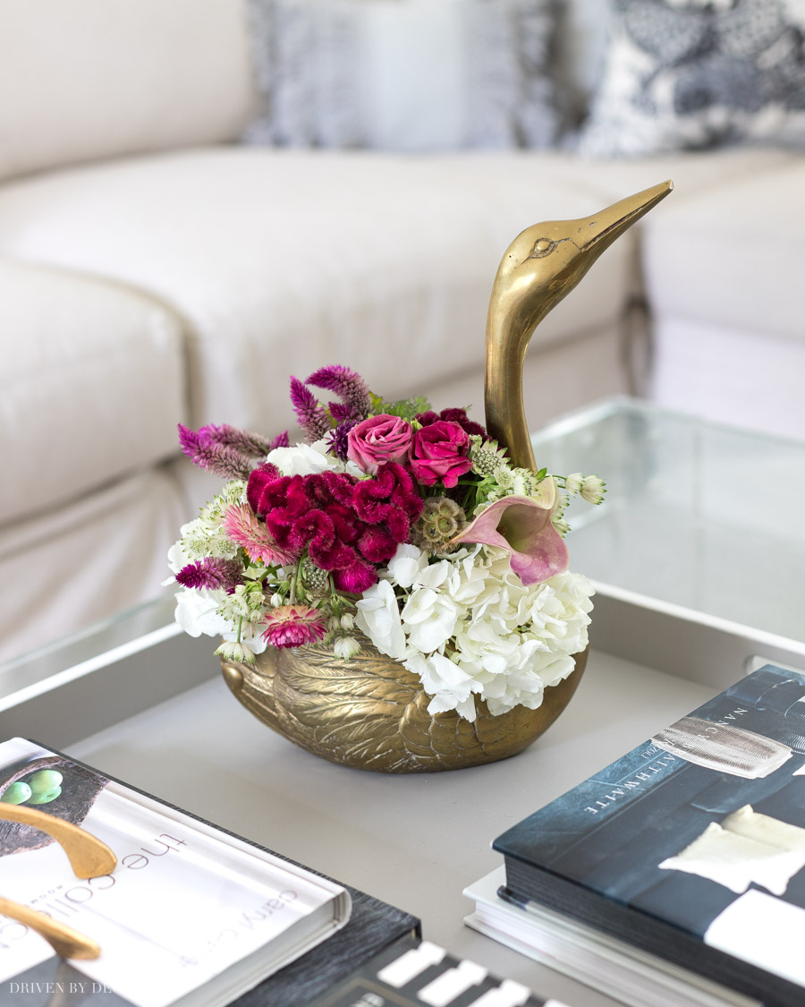 Loving this brass swan planter filled with flowers!