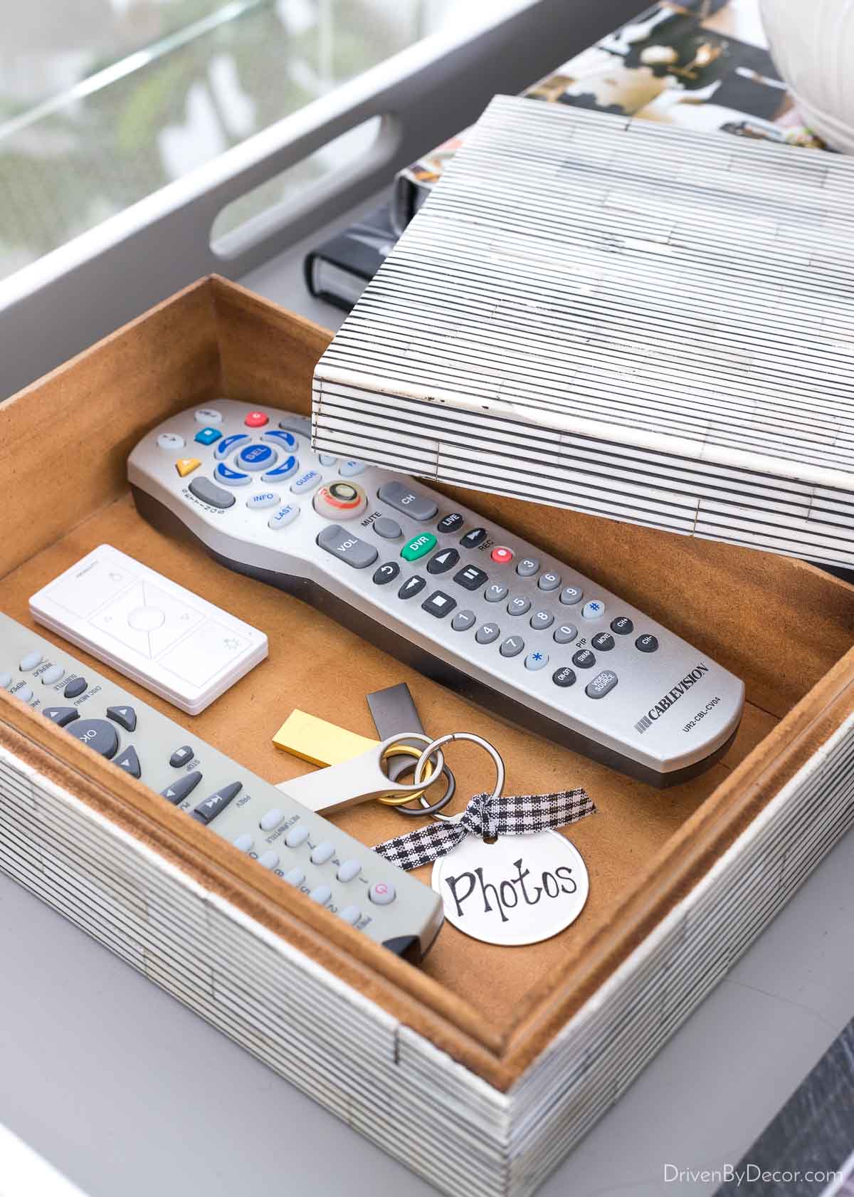 Decorative box holding remotes on living room coffee table