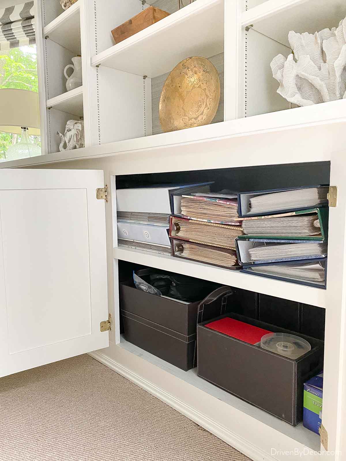 Stacks of photo albums in cabinet