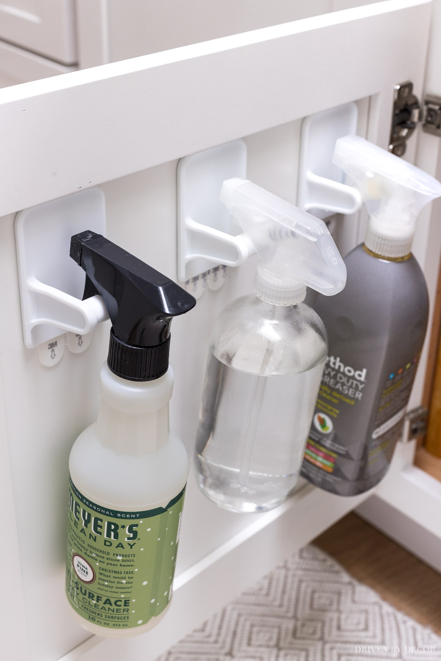 Inexpensive back-of-cabinet spray bottle hangers to keep them tucked away but easy to grab!