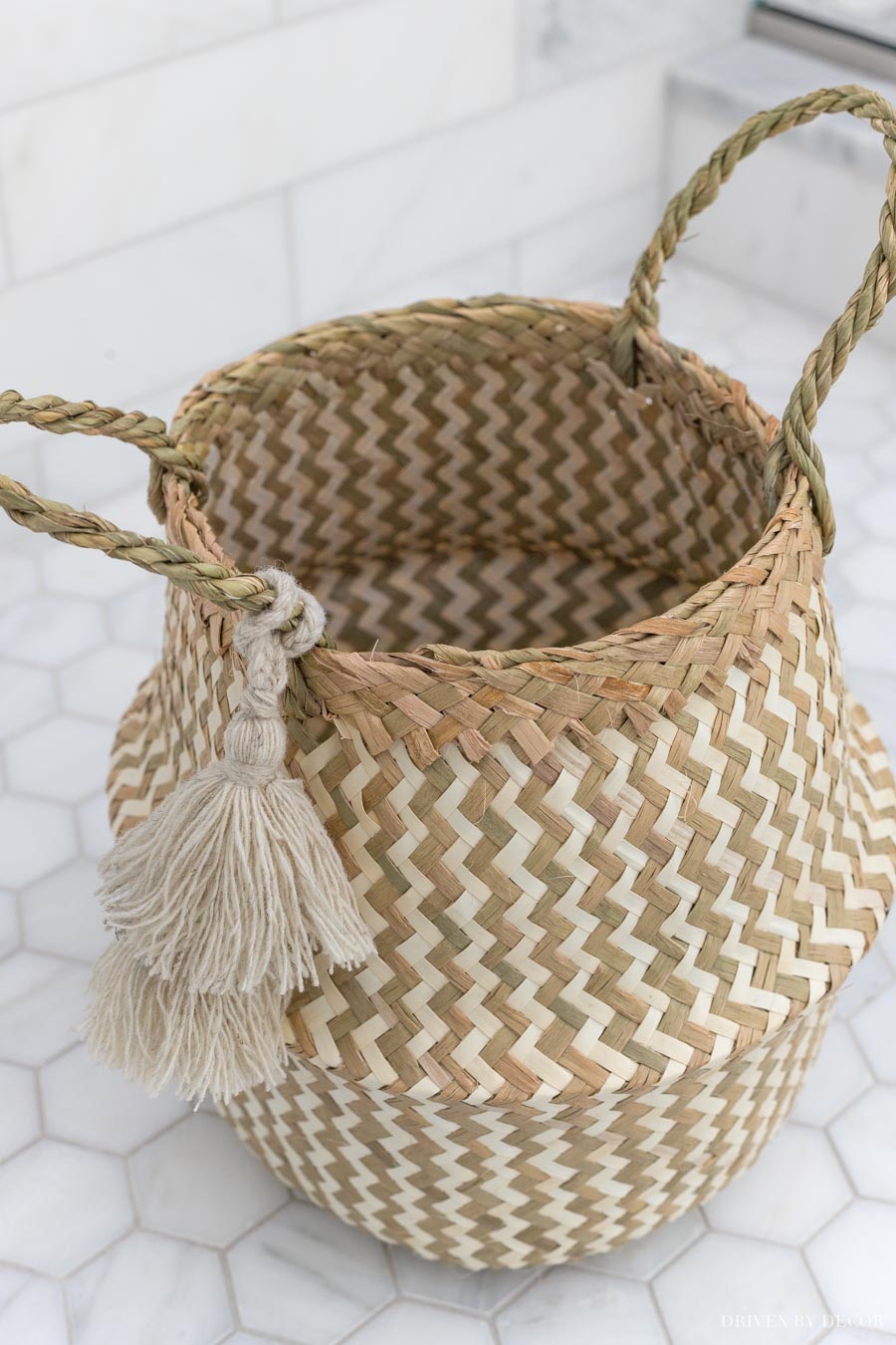 This darling woven basket with tassels is the cutest bathroom decor storage option!