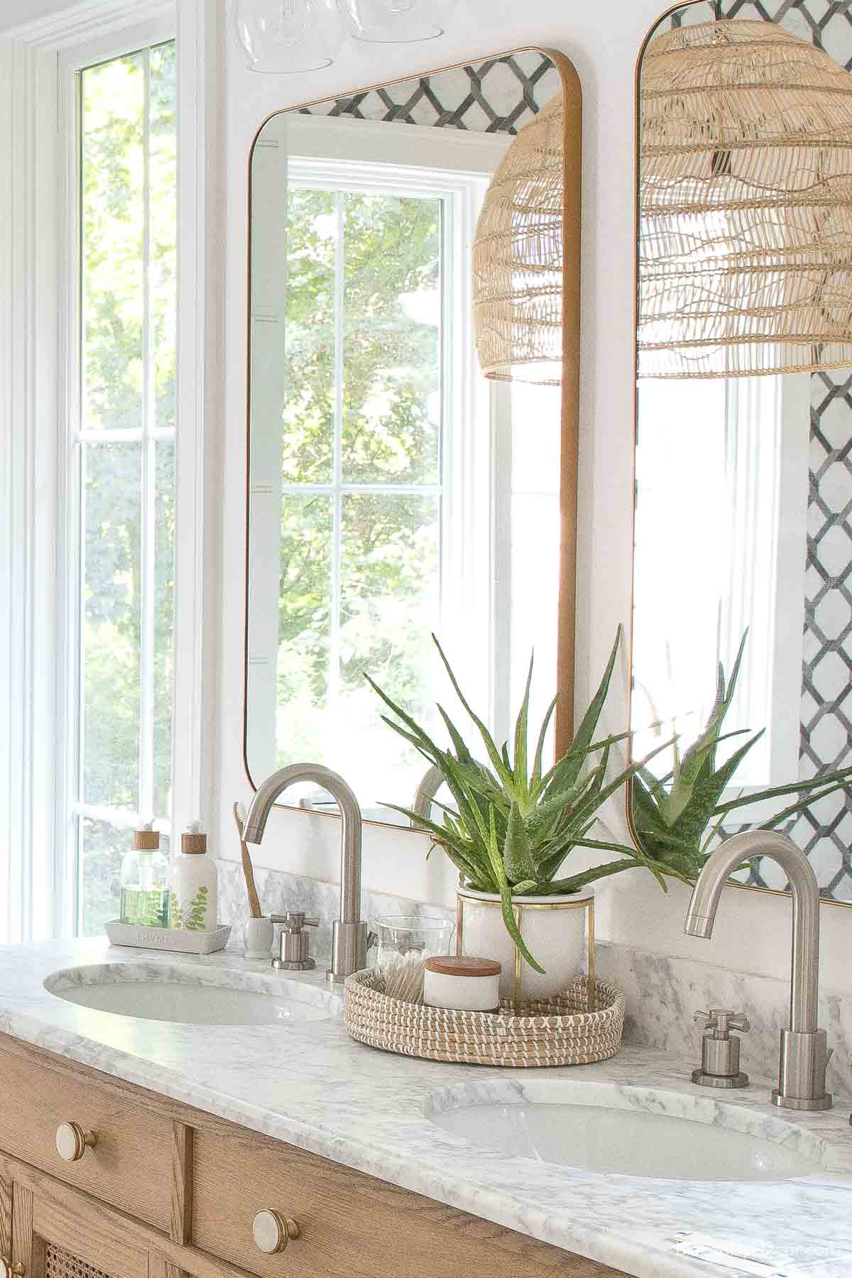 Round woven tray between sinks in bathroom