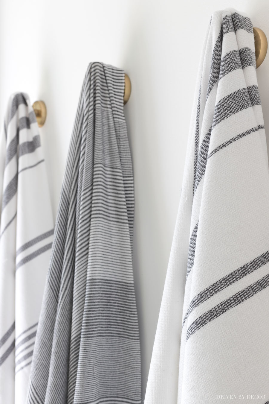 Loving the strriped towels on robe hooks in this bathroom!