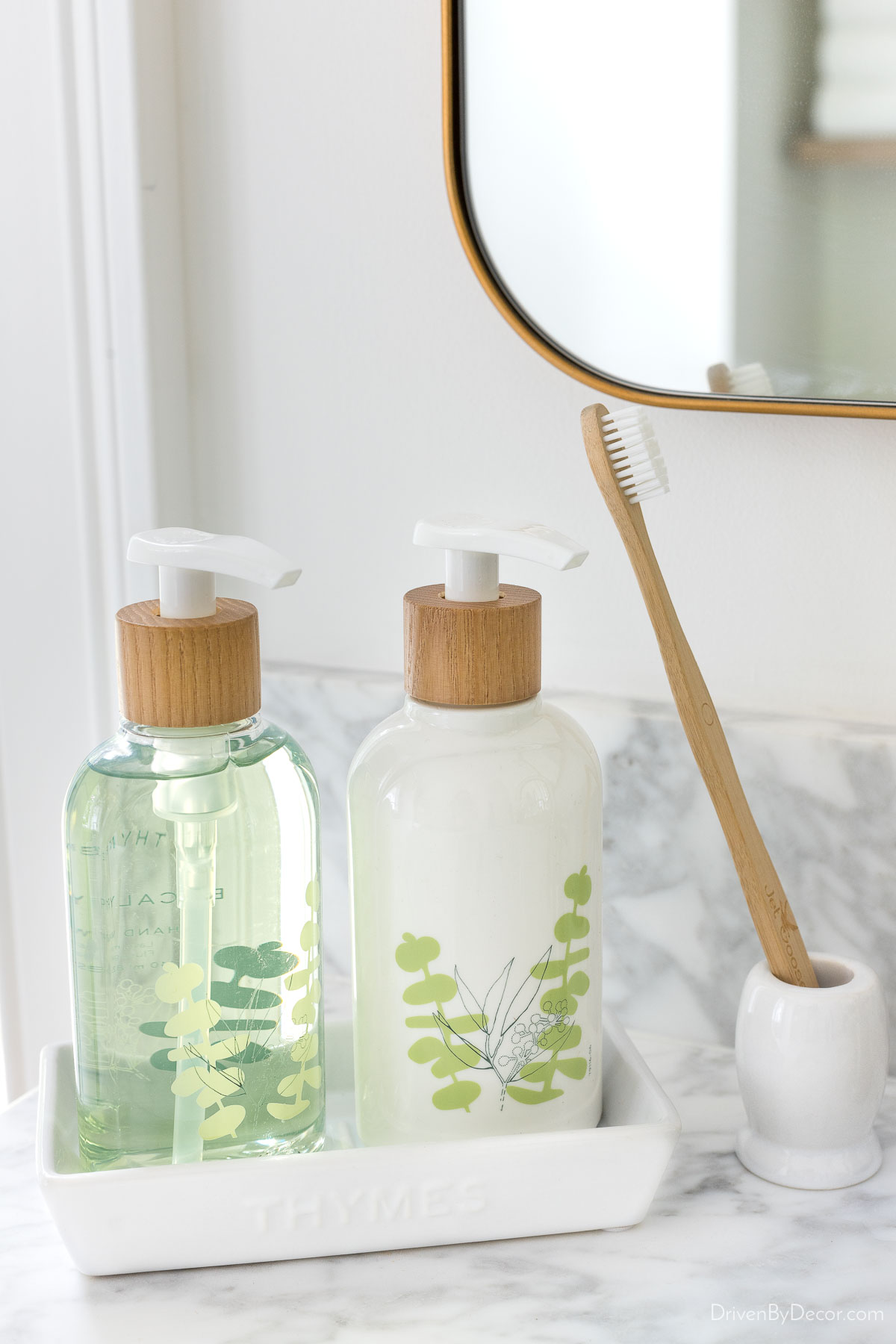 Liquid soap and lotion pumps on ceramic tray