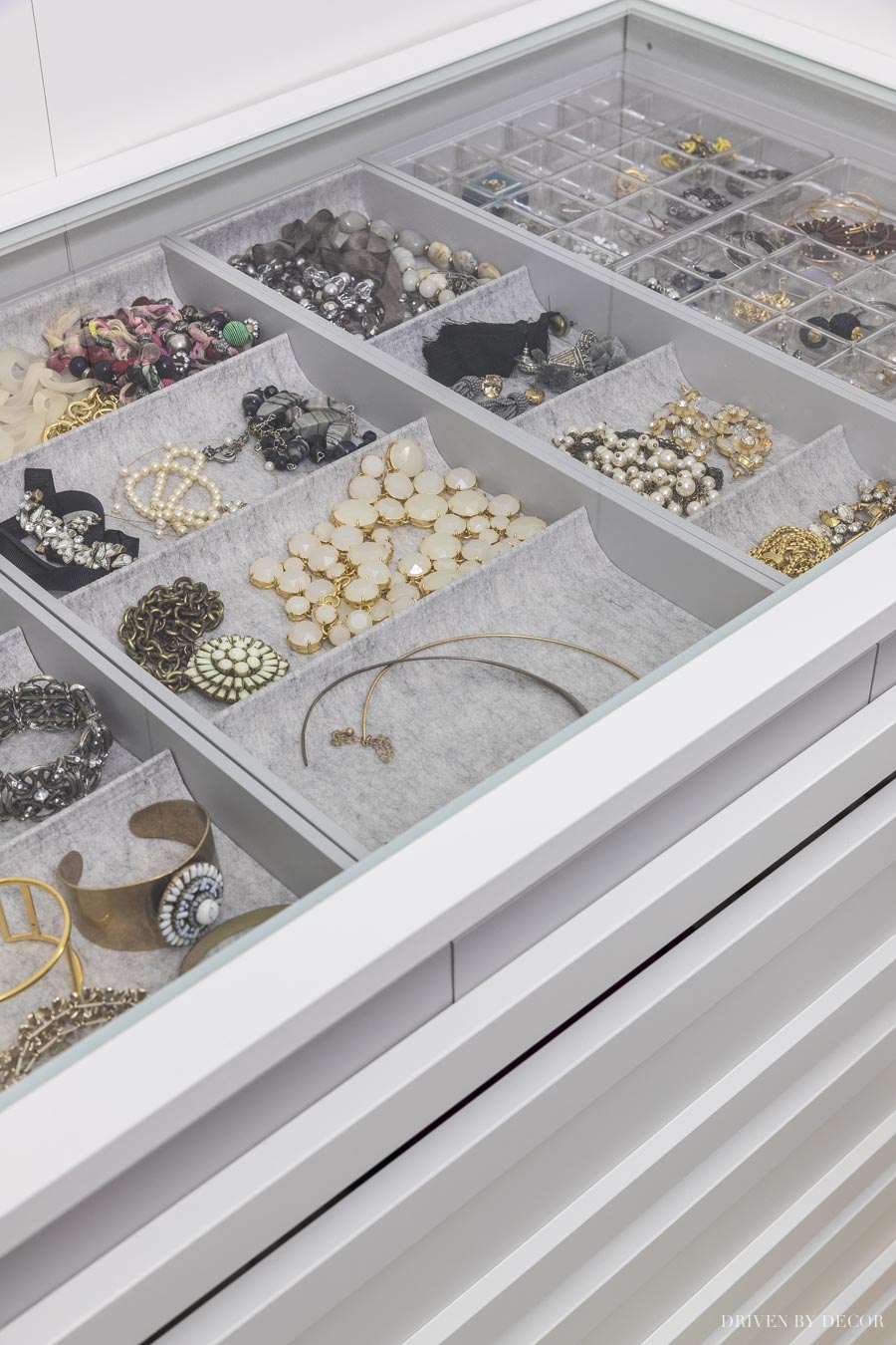 Using a glass shelf above my pull-out jewelry tray in my IKEA PAX closet allows me to see everything at a glance!