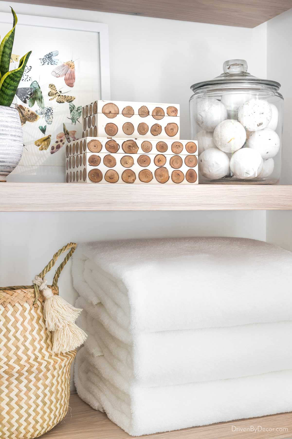 Bath bombs in a glass jar on bathroom shelves