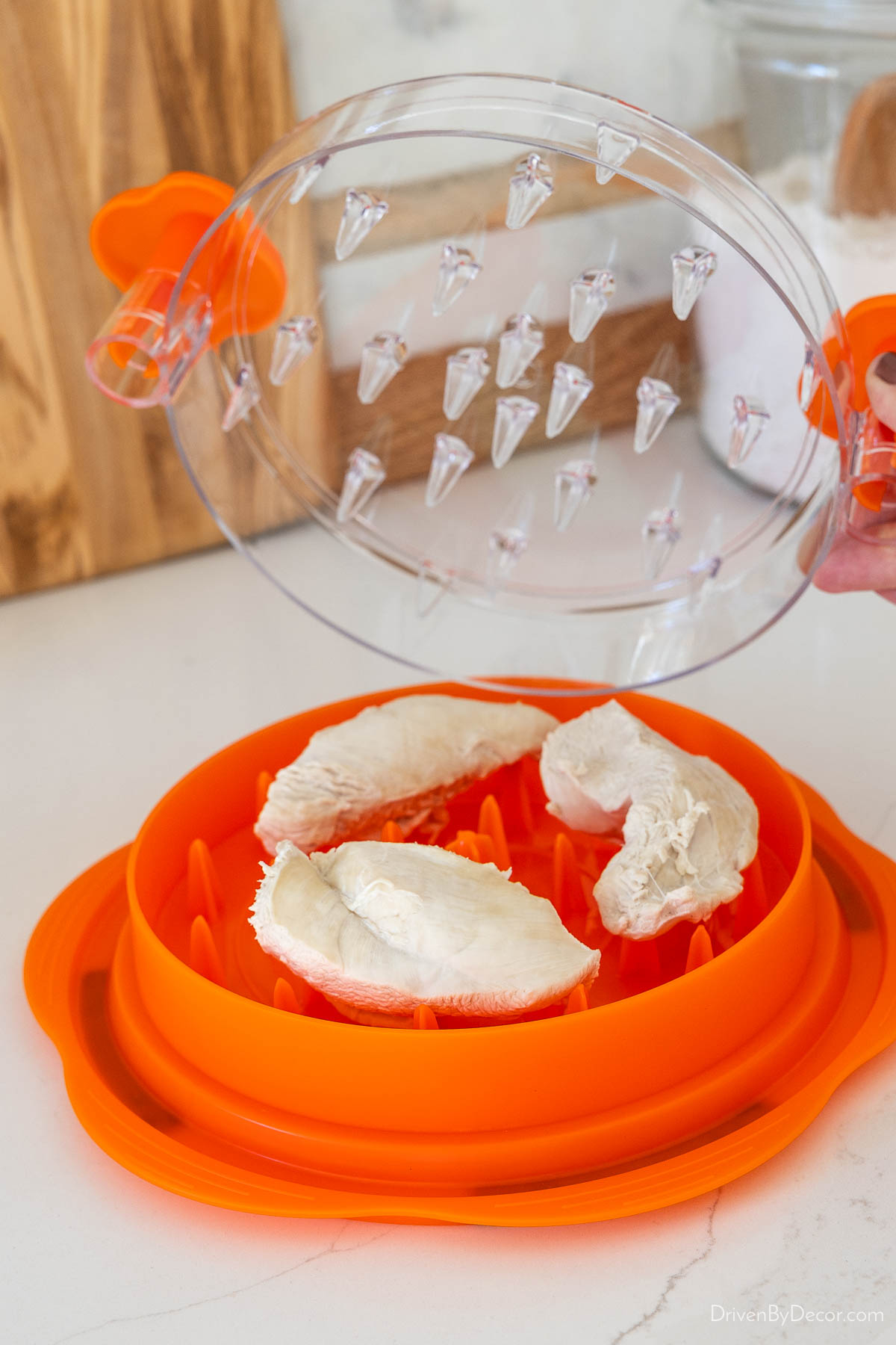 Cooked chicken placed on chicken shredder gadget