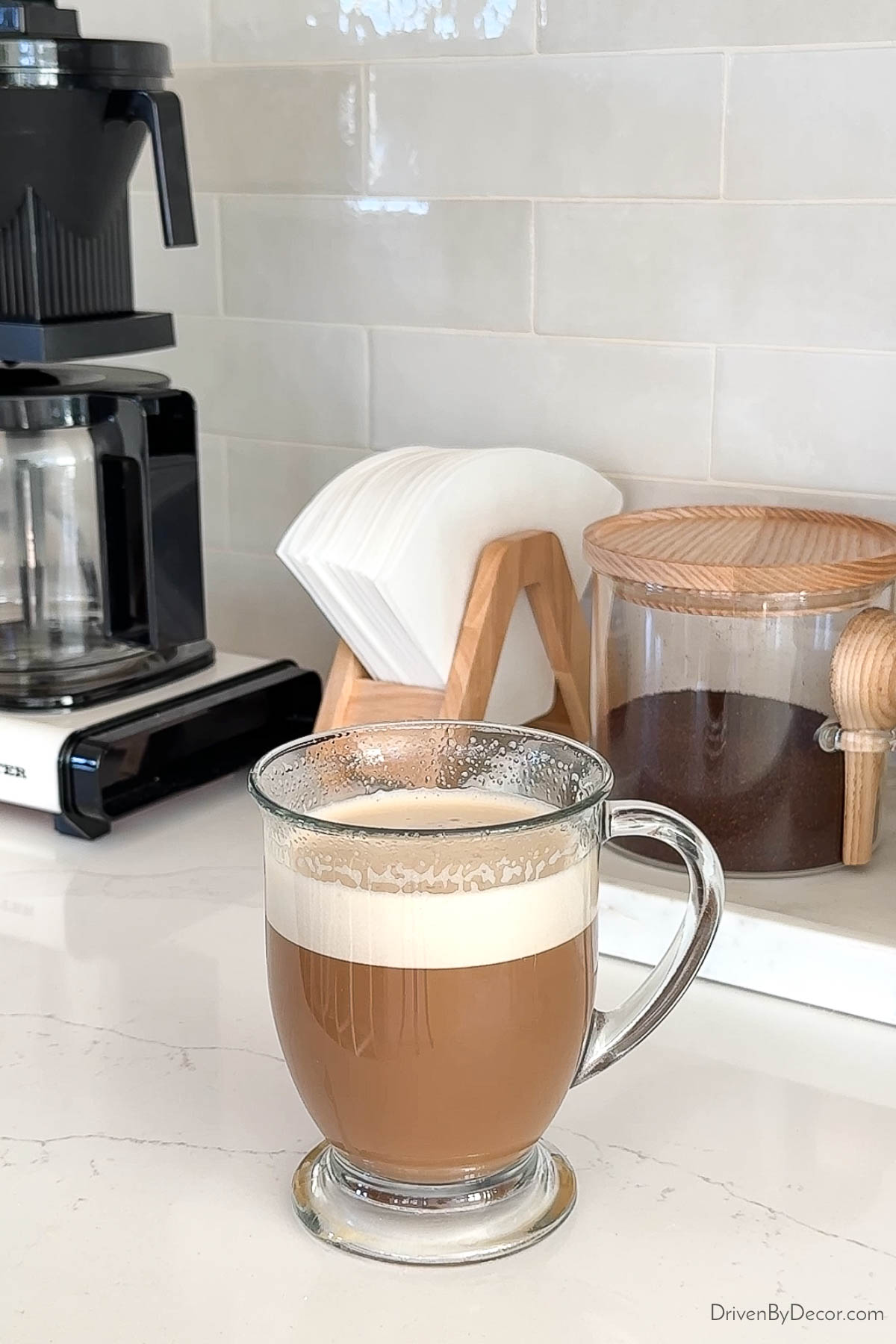Cup of coffee with creamy froth due to milk frother