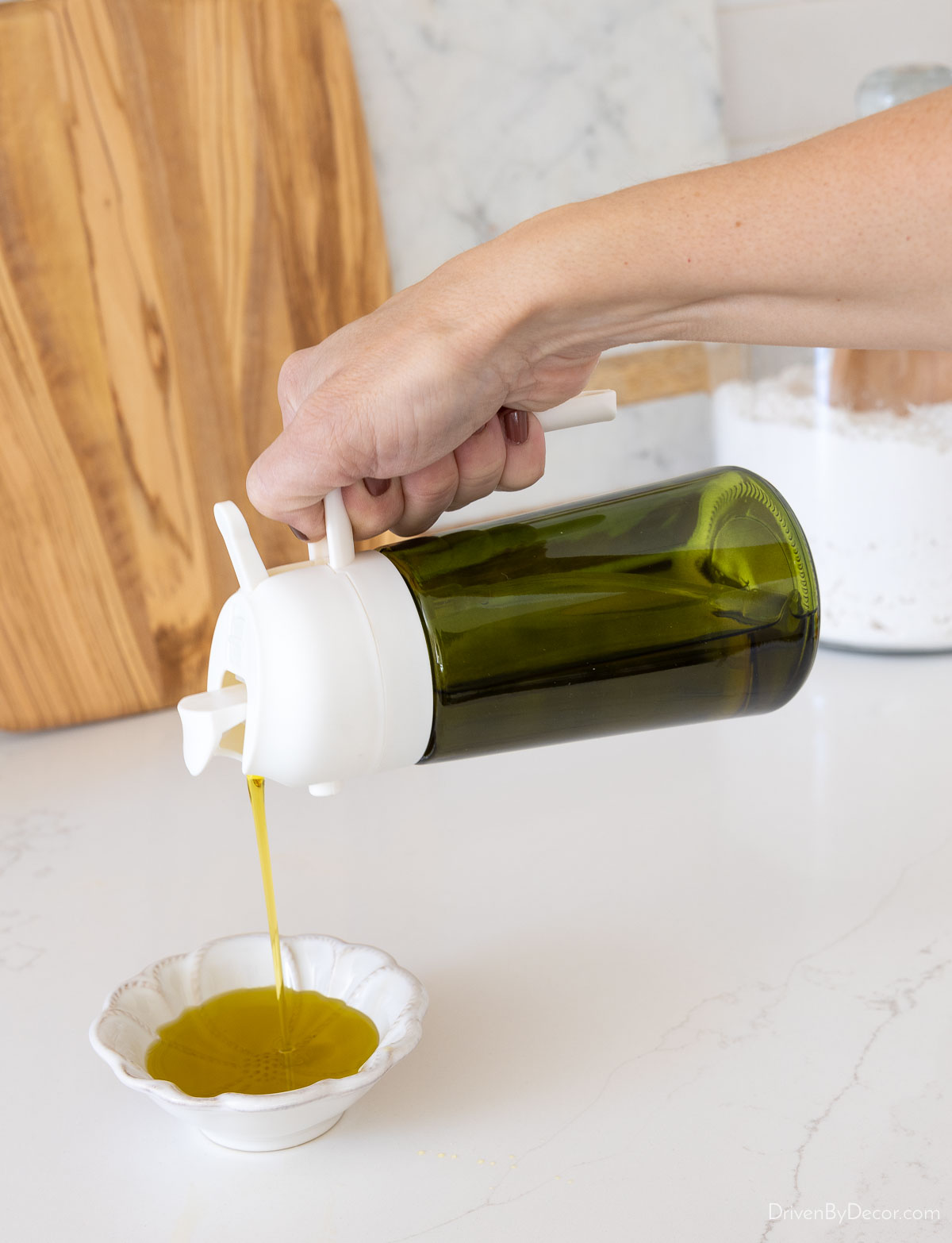 Pouring olive oil into dish