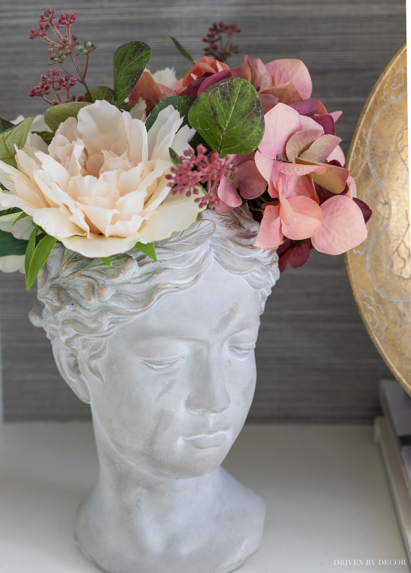 Faux fall flowers in the prettiest bust planter!