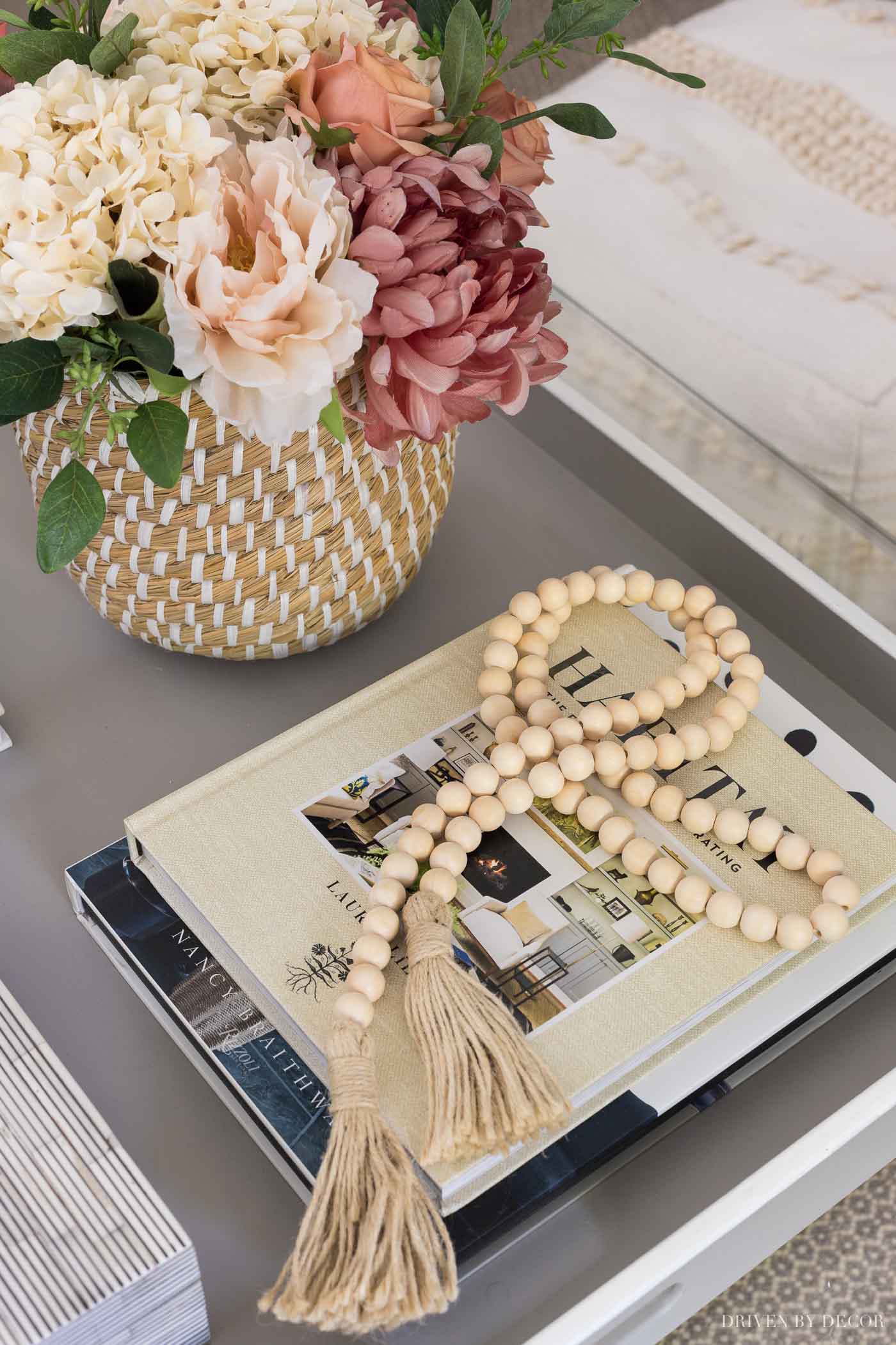 Strand of wood beads with tassels as the perfect fall decor for your coffee table!