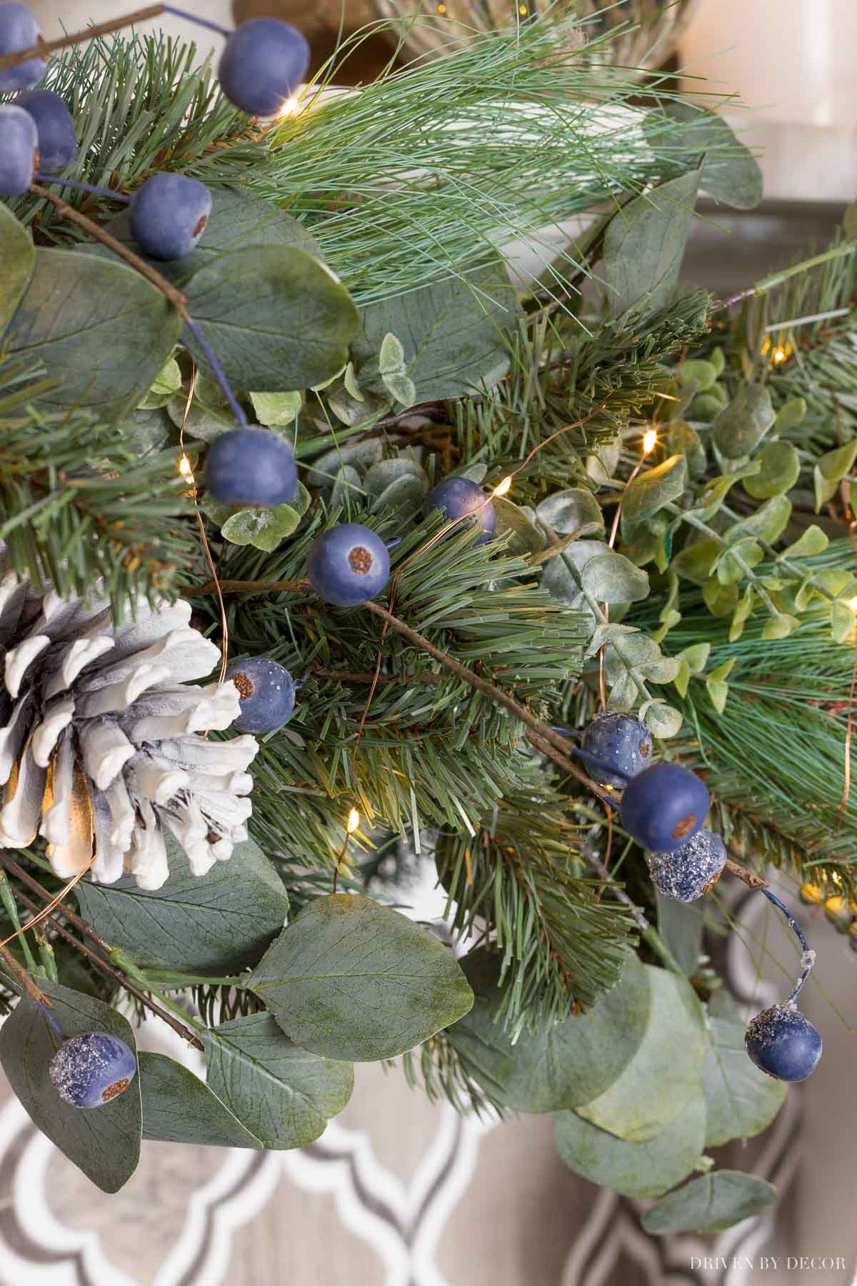 Our Christmas garland with faux pine, eucalyptus, frosted berries, and pinecones