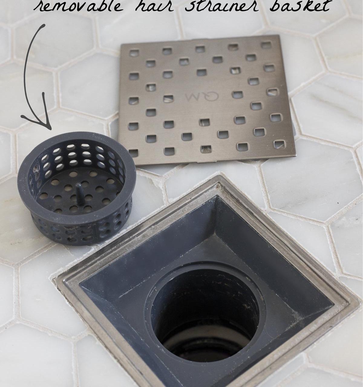 This shower drain has a removable hair strainer basket - such a smart master bathroom remodel idea!