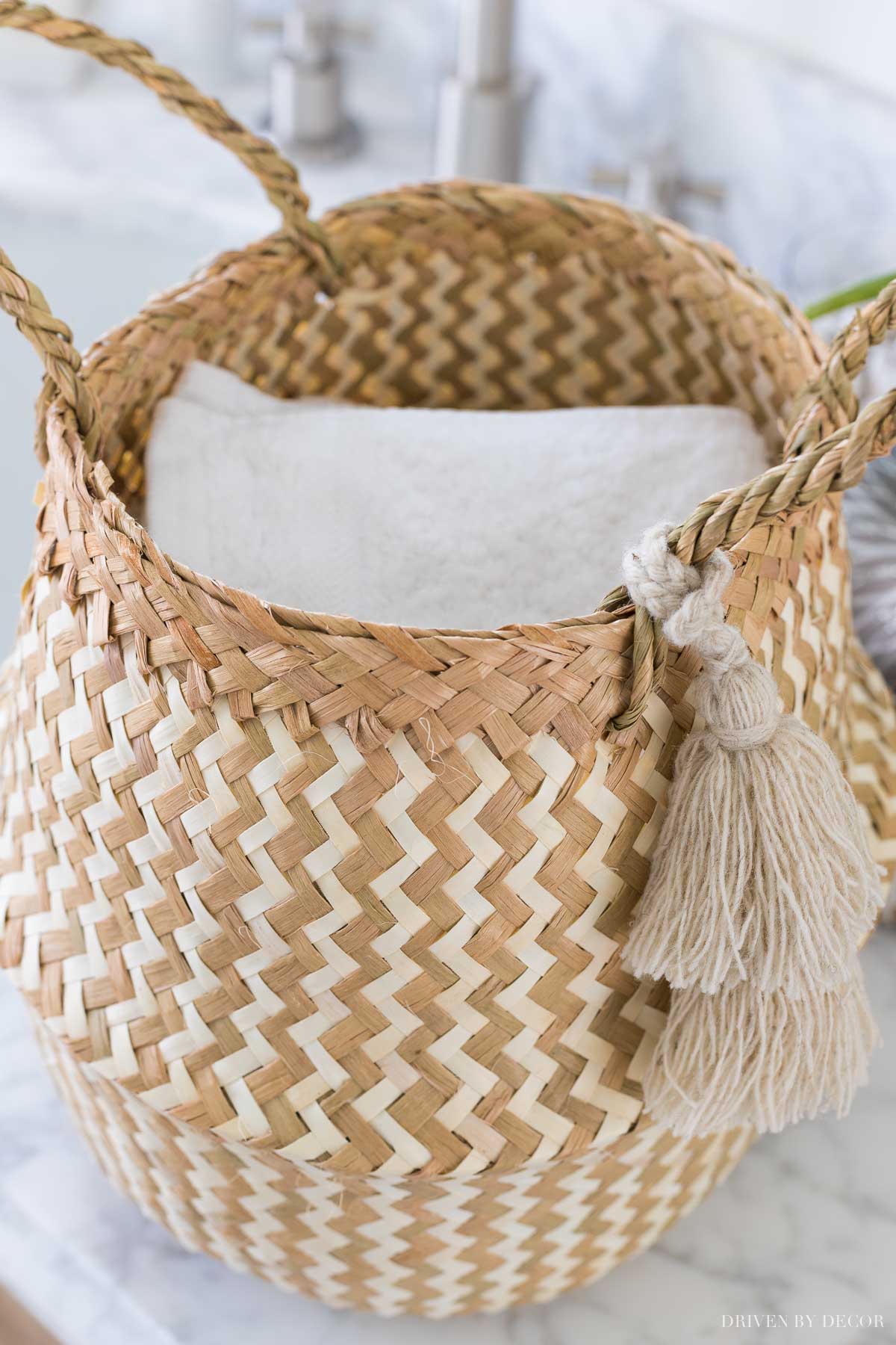 Love this cute basket holding wash cloths on the floating shelves in her master bathroom!