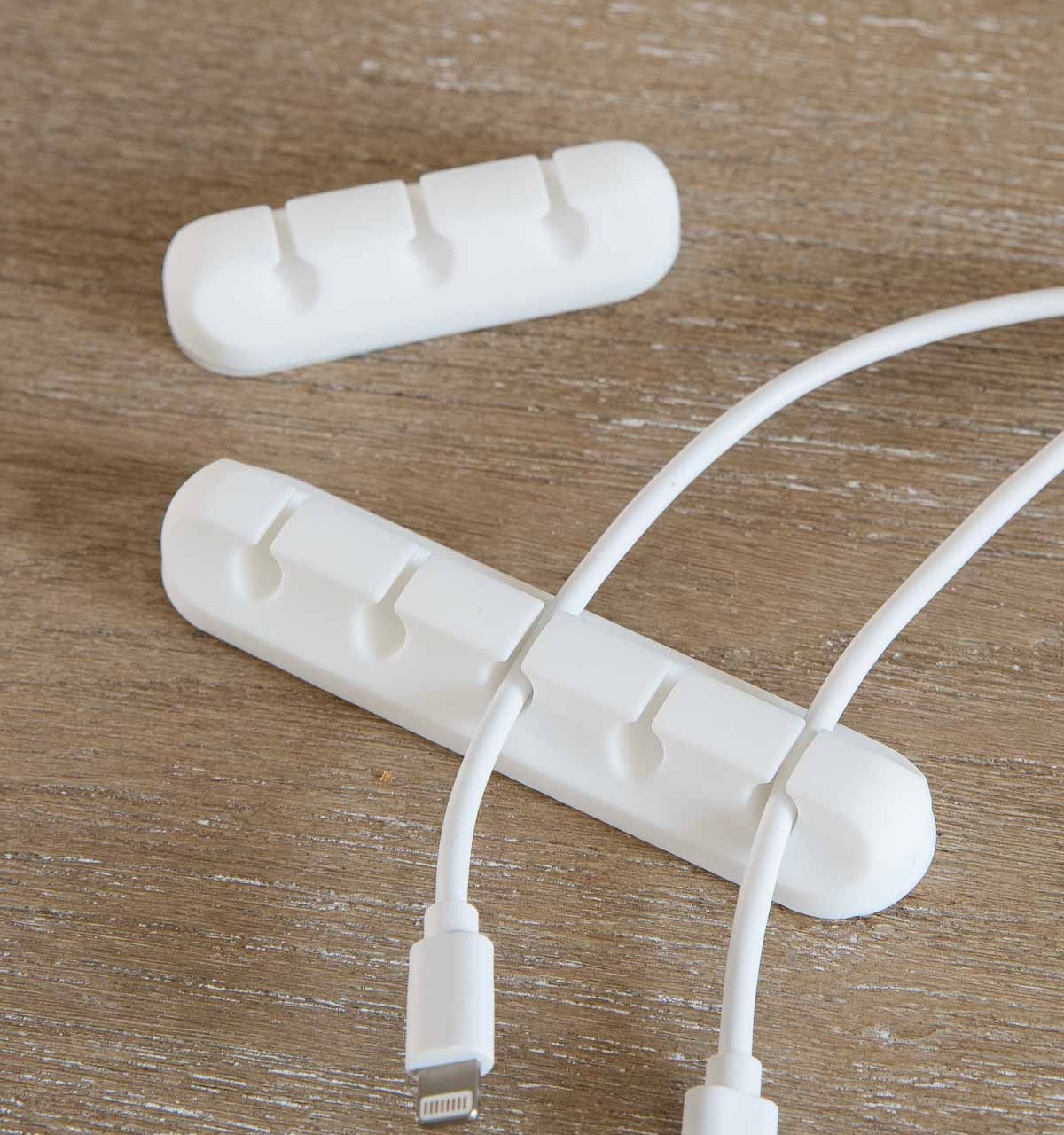 These adhesive cord holders are awesome for keeping cords from slipping behind your desk!