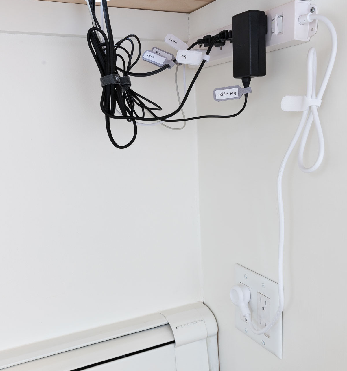 How we corral our cords under our desk - one of my favorite desk organization ideas!