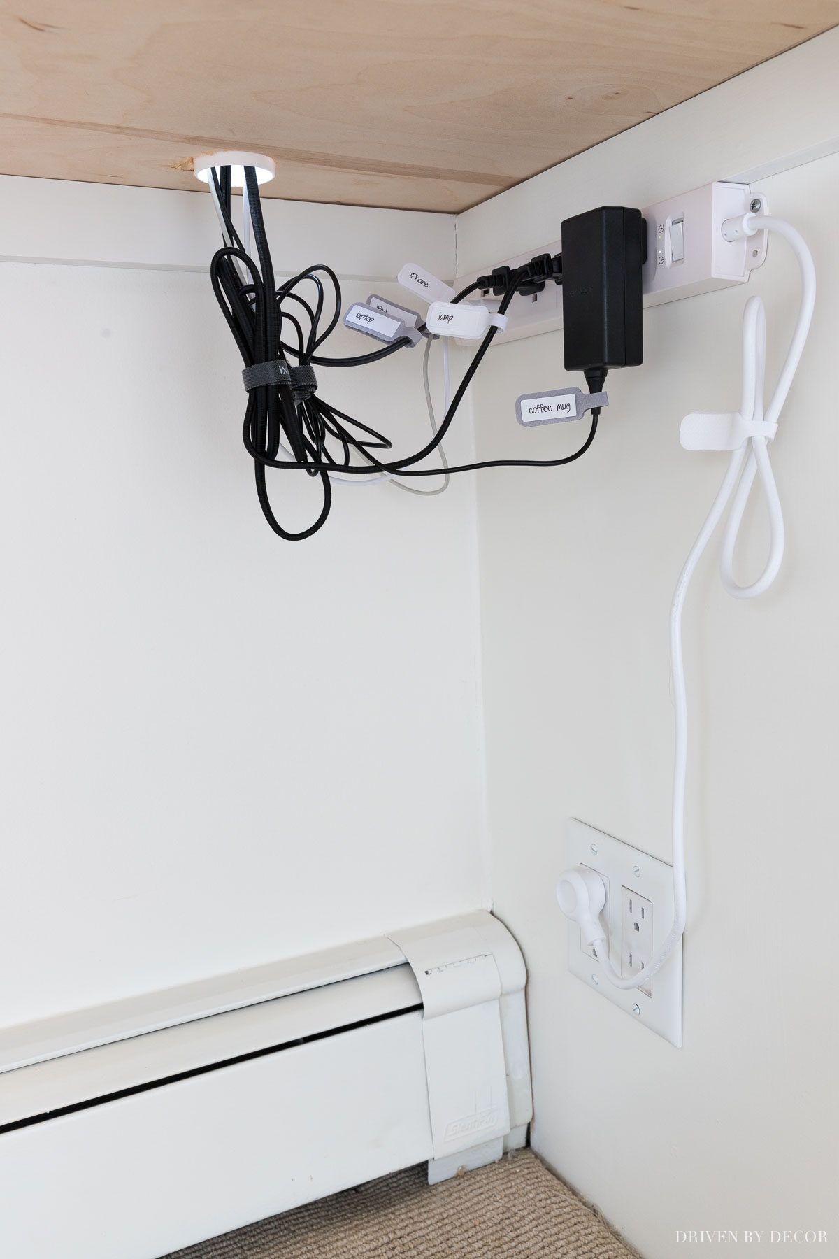 How we corral our cords under our desk - one of my favorite desk organization ideas!