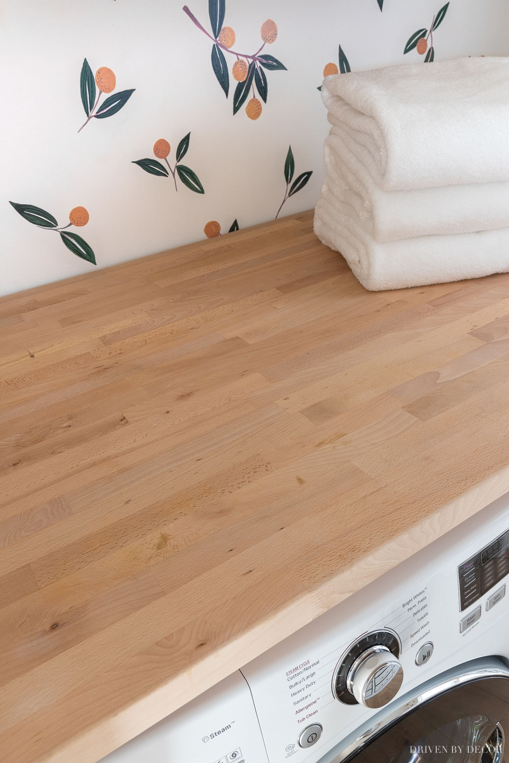 This Ikea wood countertop (butcher block) added a great space to fold and sort clothes in our laundry room!