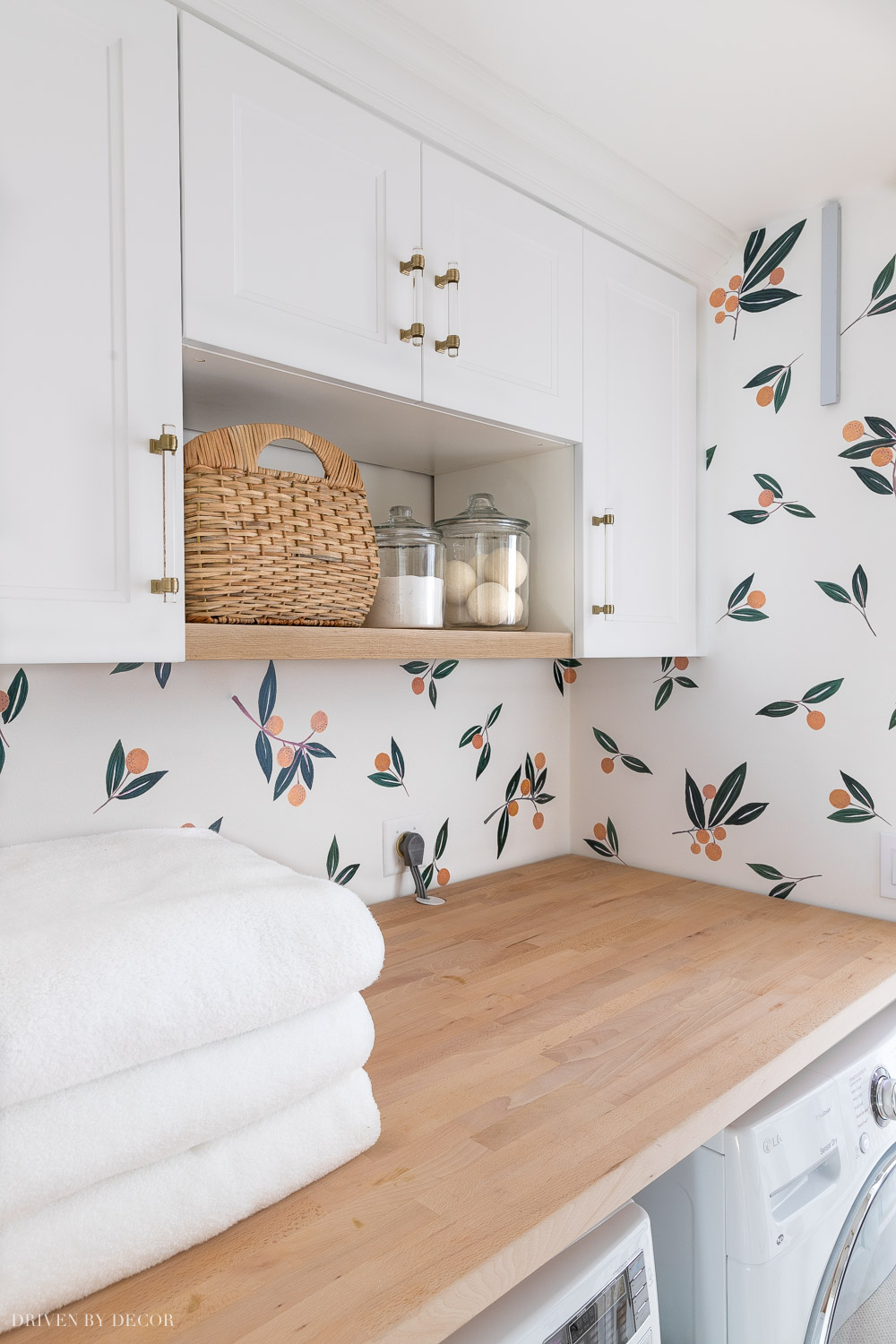 We used Ikea Sektion cabinet frames and Axstad doors to create storage over our laundry room washer and dryer!