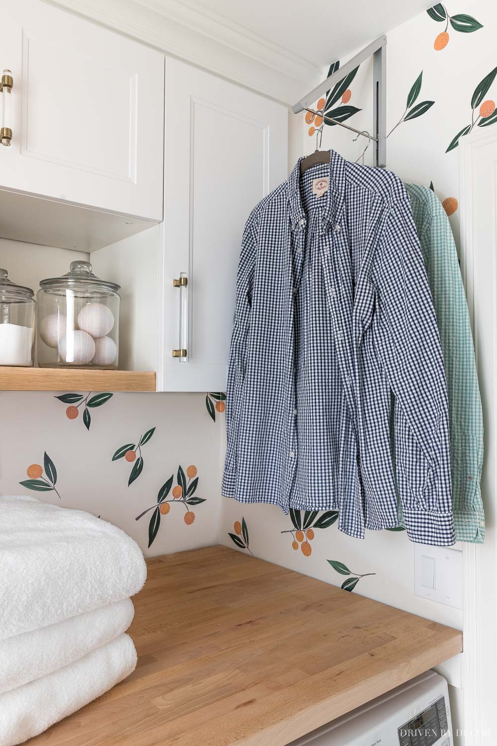 Love this retractable clothes rack for hanging clothes to dry in our laundry room!