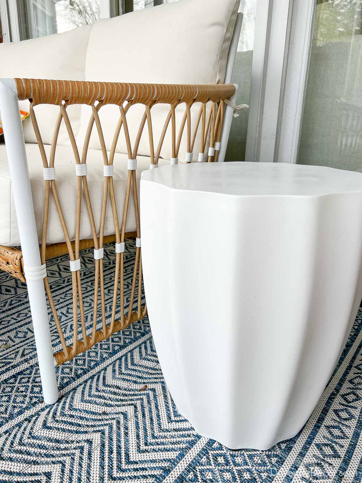 The scalloped white concrete stool we added to our outdoor space