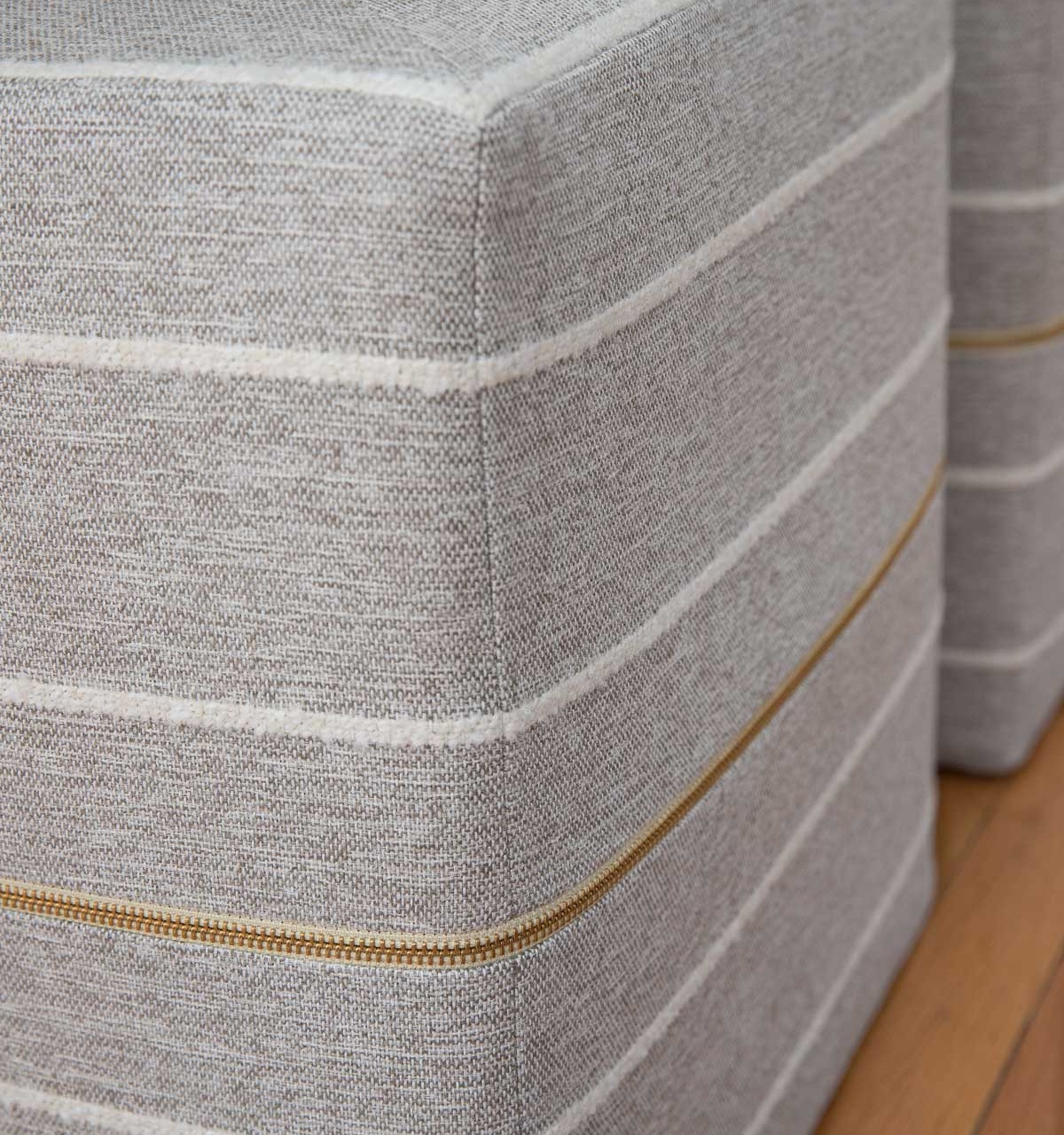 Love the gorgeous brass zippers on these cube ottomans!