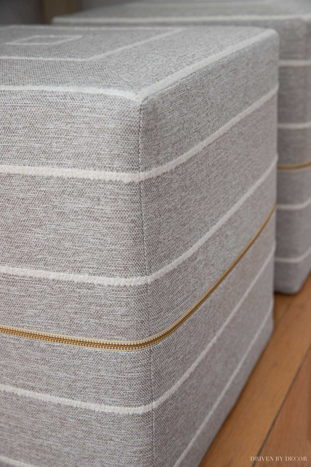 Love the gorgeous brass zippers on these cube ottomans!