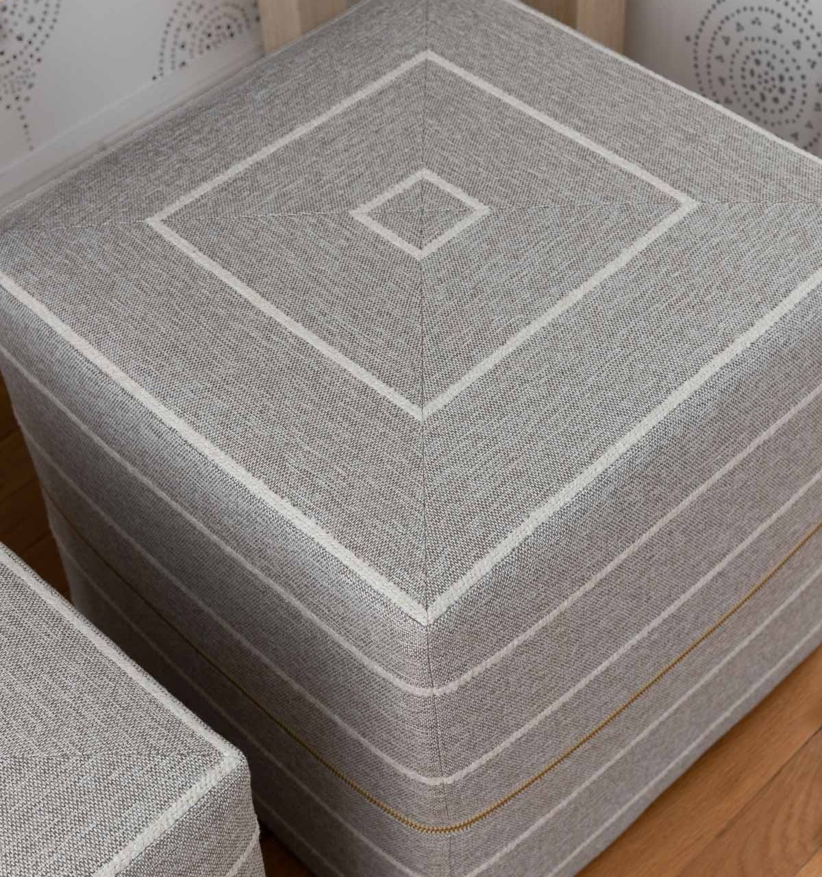 The gorgeous pair of gray and white ottomans under our entryway console table