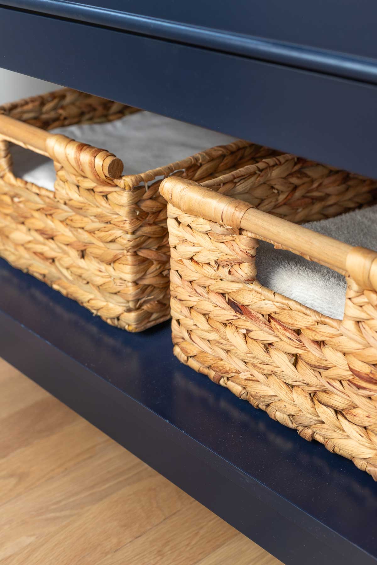 Baskets on bottom shelf of small vanity