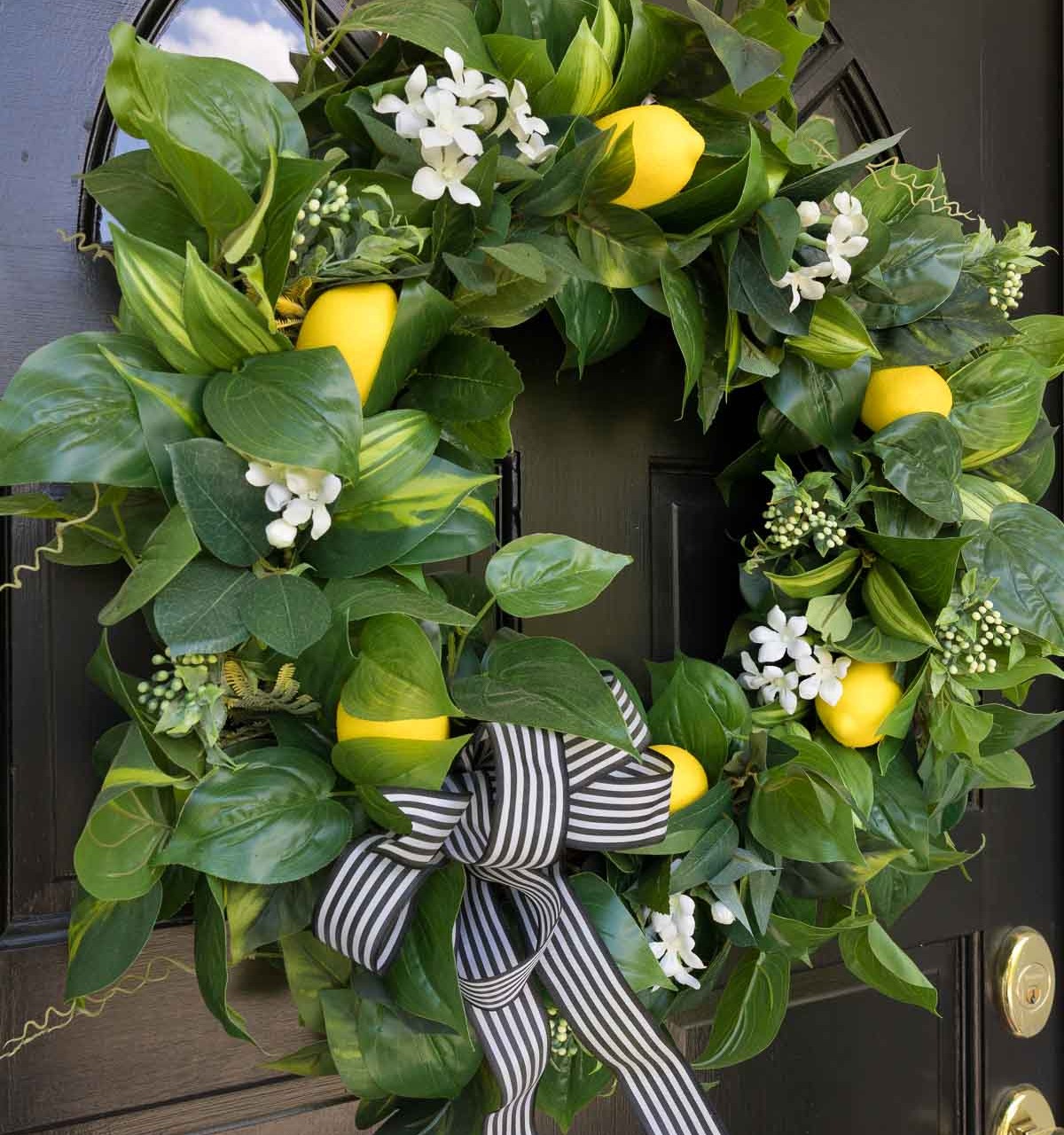 Our spring wreath with artificial greenery, flowers, and lemons!