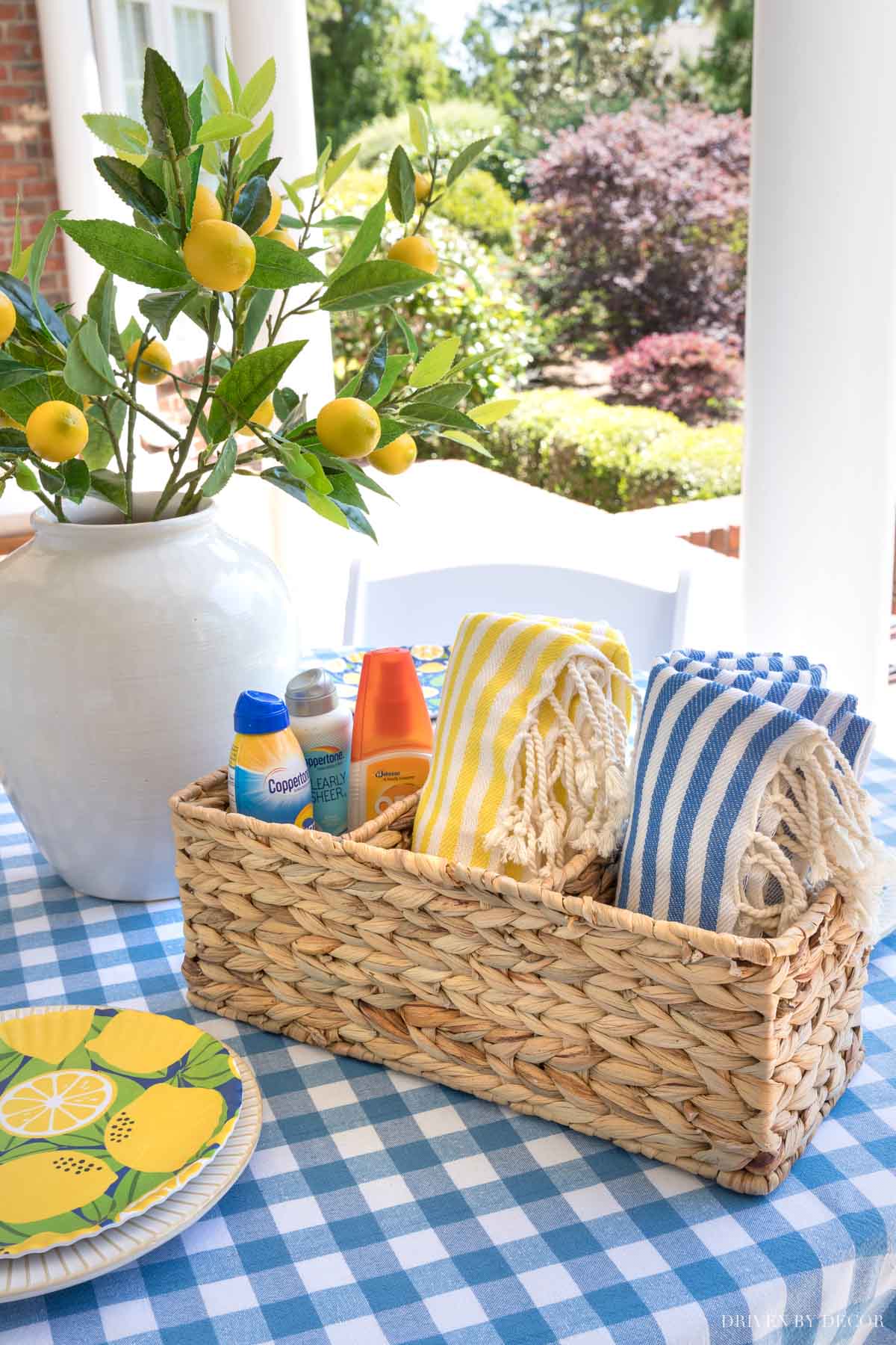 This woven basket holds outdoor essentials like sunscreen, bug spray, and Turkish towels for when it gets chilly!