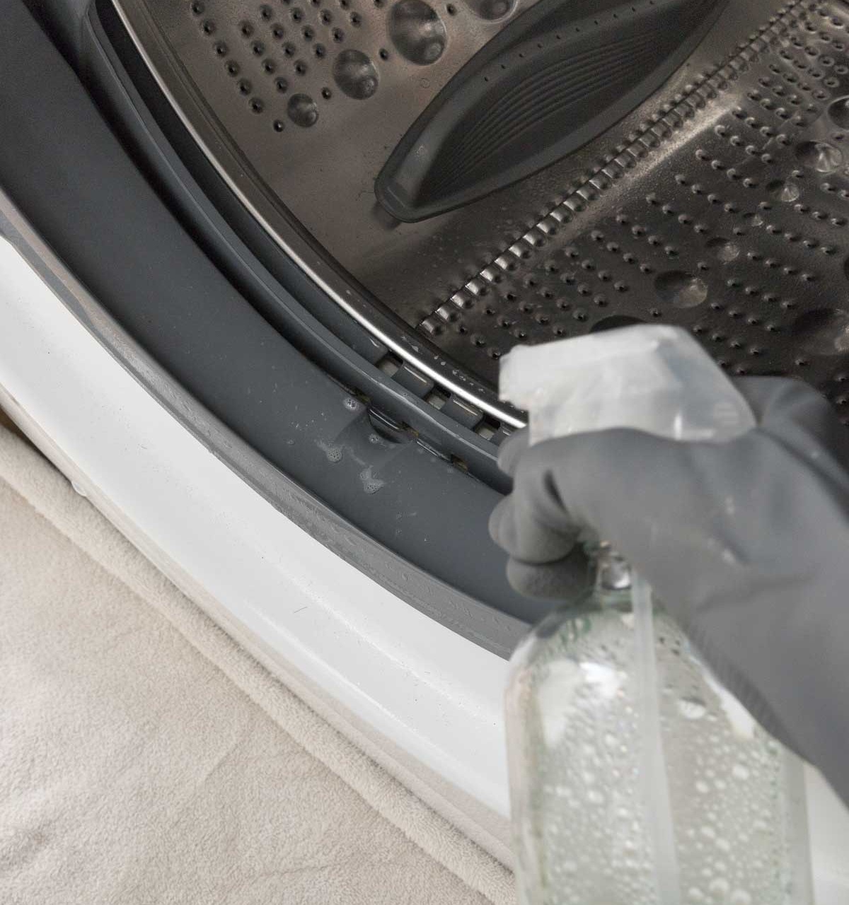 Spraying diluted bleach on your washing machine seal before scrubbing it is the best way I found to get it clean!