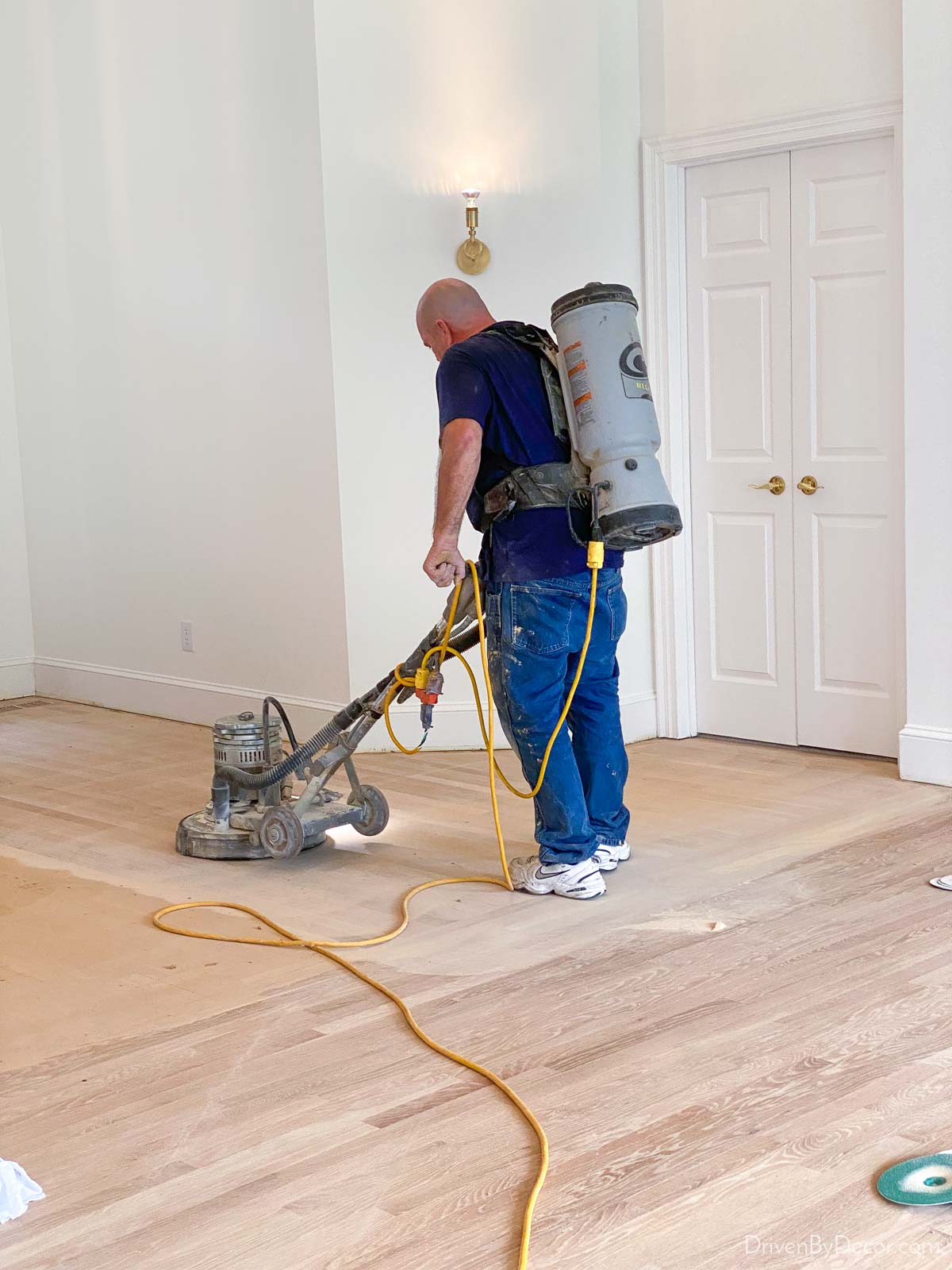 Dustless hardwood floor refinishing - sanding equipment is hooked up to a vacuum