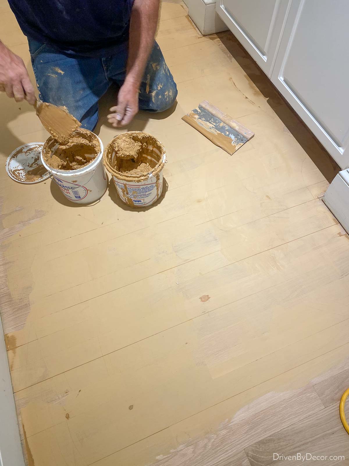 Applying wood filler to patch imperfections in wood floor before refinishing